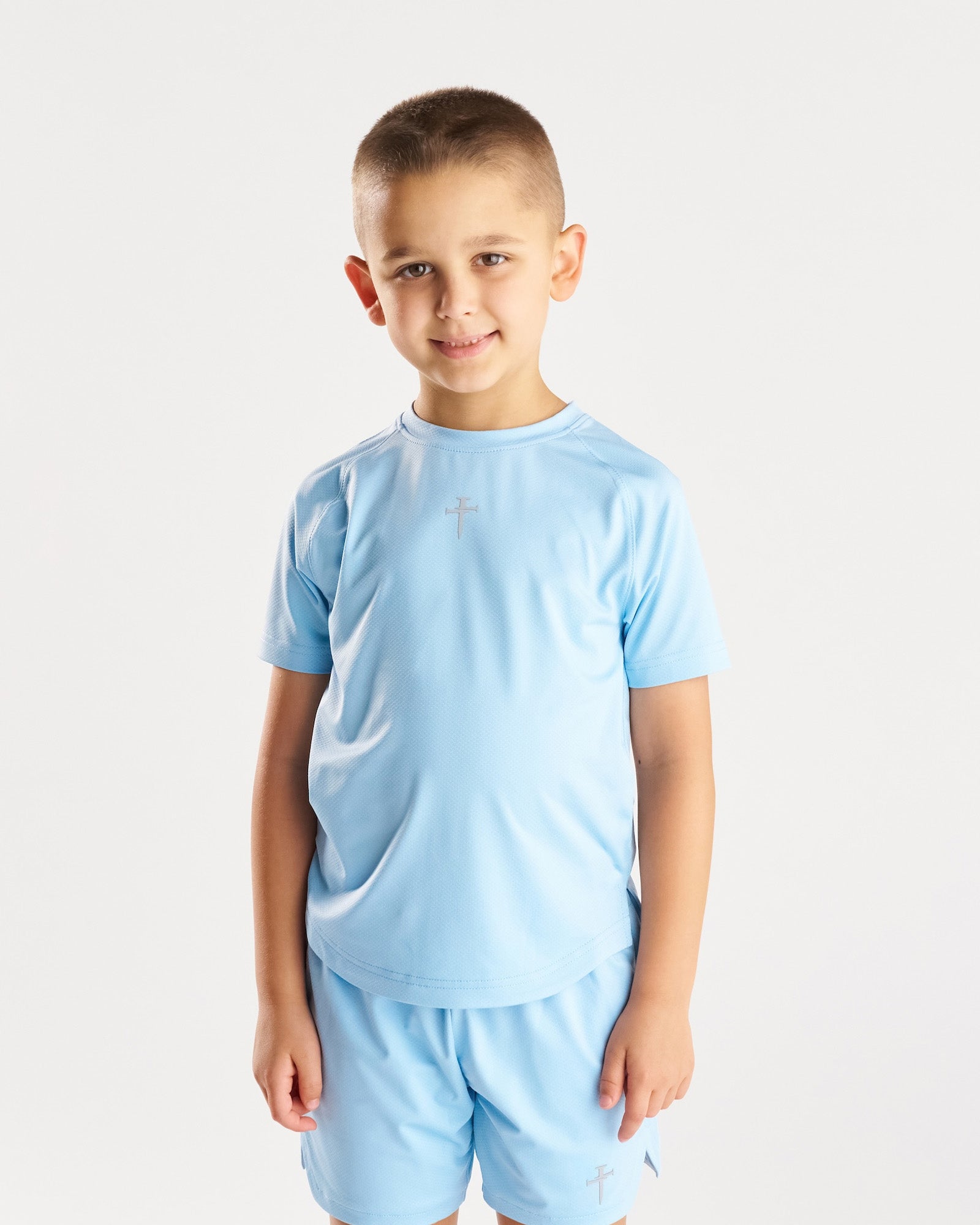 Youth Pro-Tech Tee Cross in Sky Blue front view on young boy model with matching shorts.
