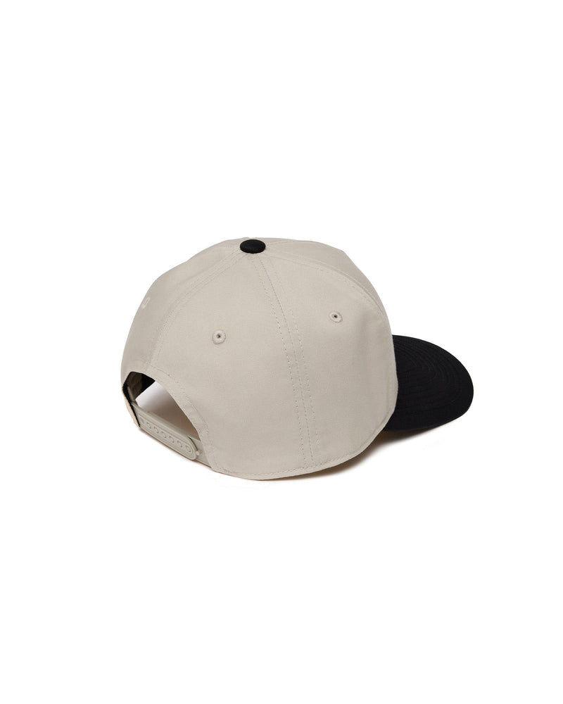 Signature Two-Tone Hat Bundle Pack in cream and black, flatlay showing back angle with snapback closure.