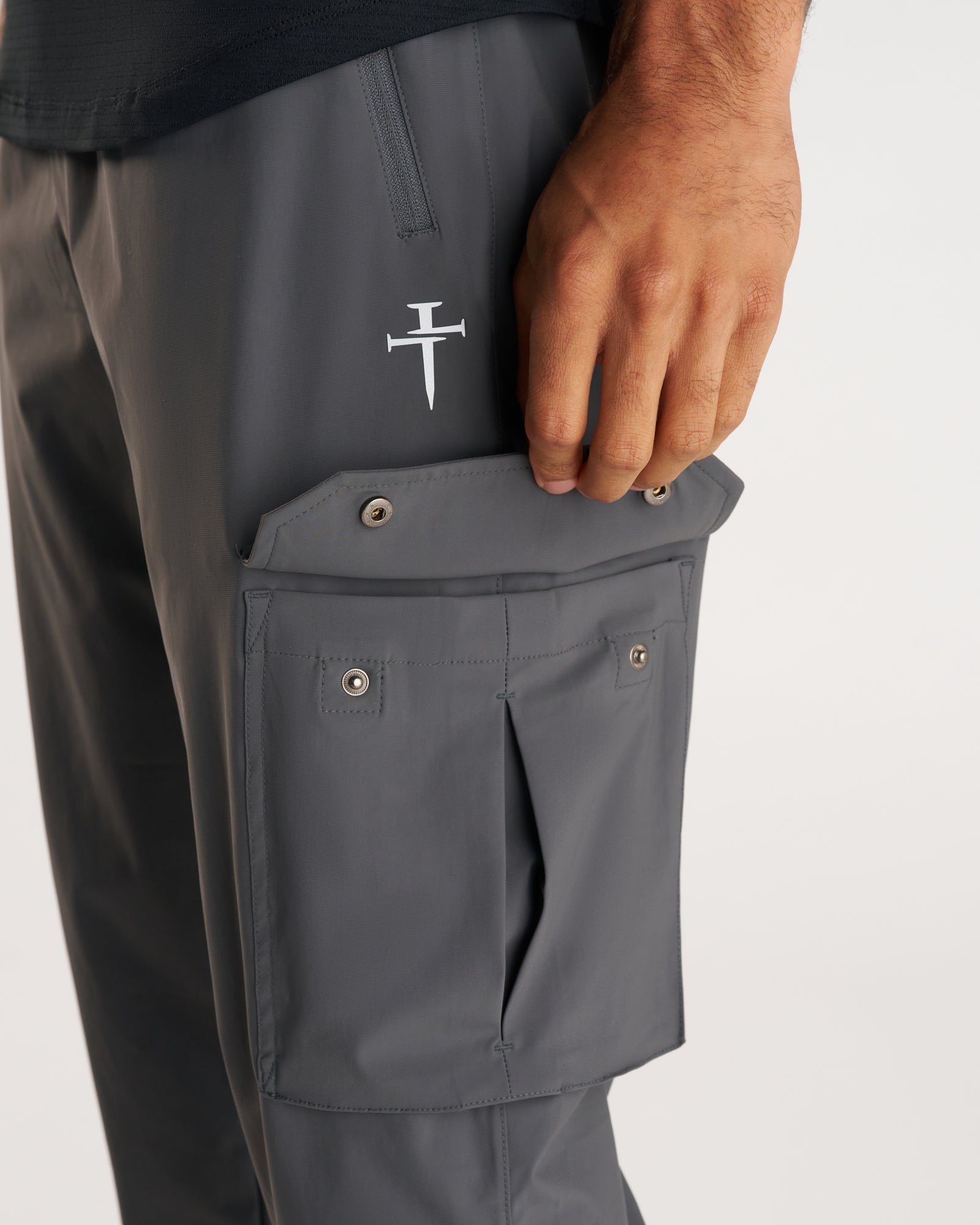 Close-up of Space Grey Vapor-Lite Cargo Jogger side cargo pocket with snap closure and Three Nails logo.