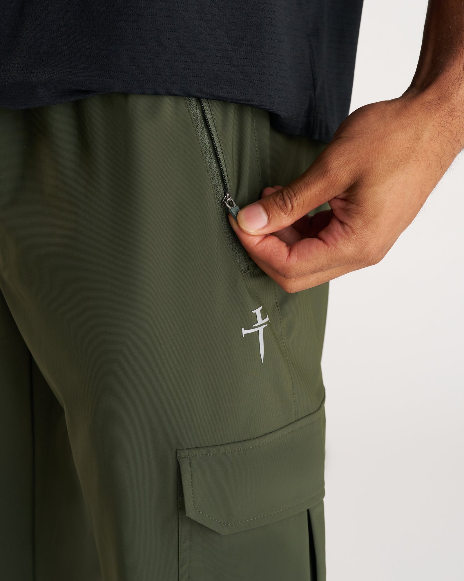 Close-up of Vapor-Lite Cargo Jogger in Dark Pine showing zipper pocket detail and cargo pocket.