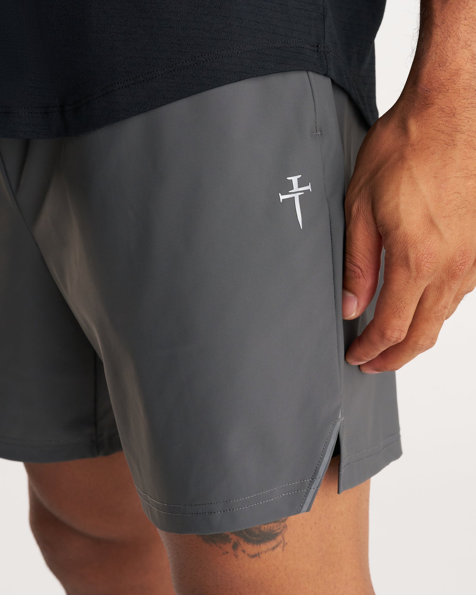 Close-up detail of Space Grey Vapor-Lite Liner Short showing the white cross logo and side seam vent.