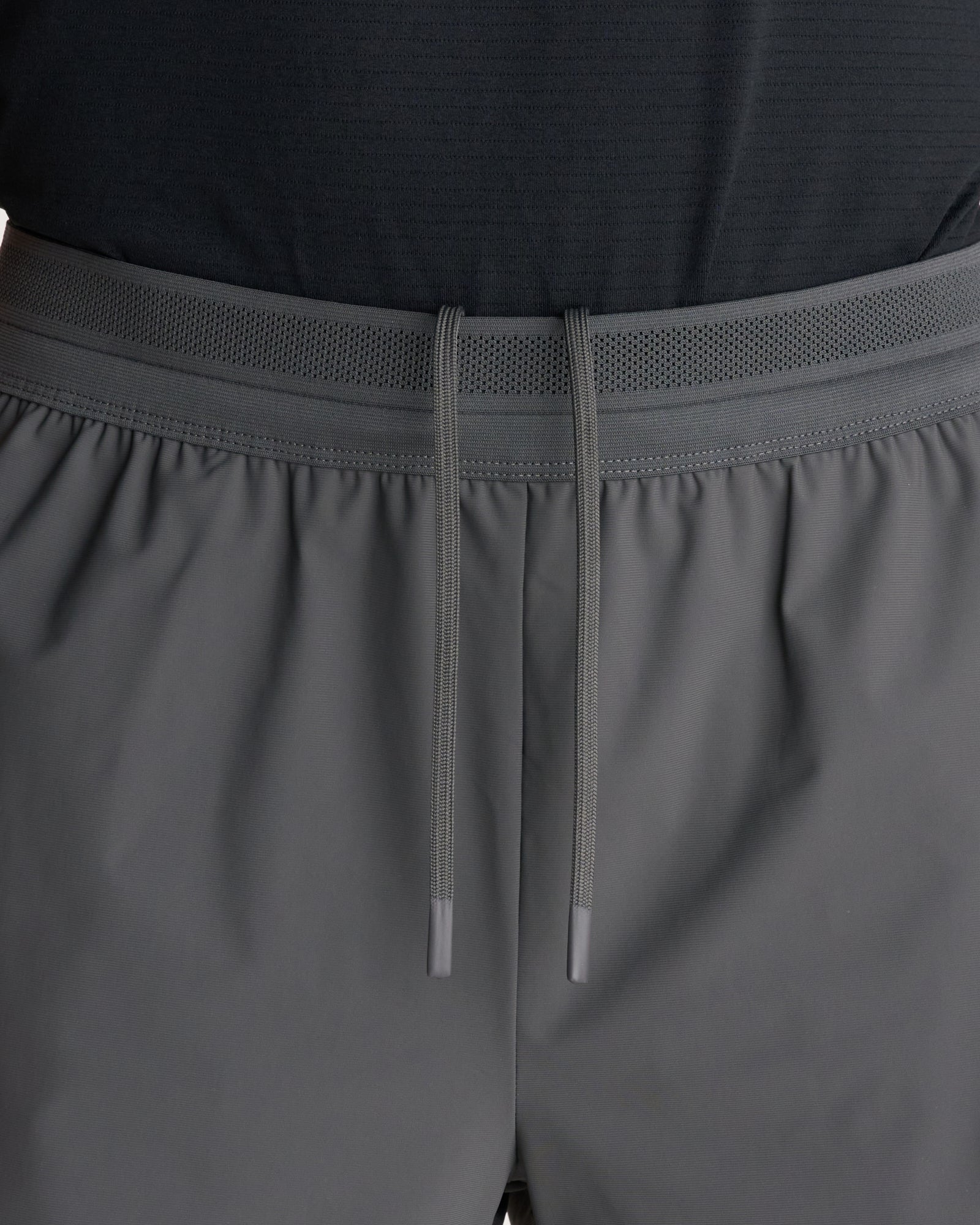 Close-up of the Vapor-Lite Liner Short Cross in Space Grey showing the elastic waistband with mesh panel and drawcord detail.