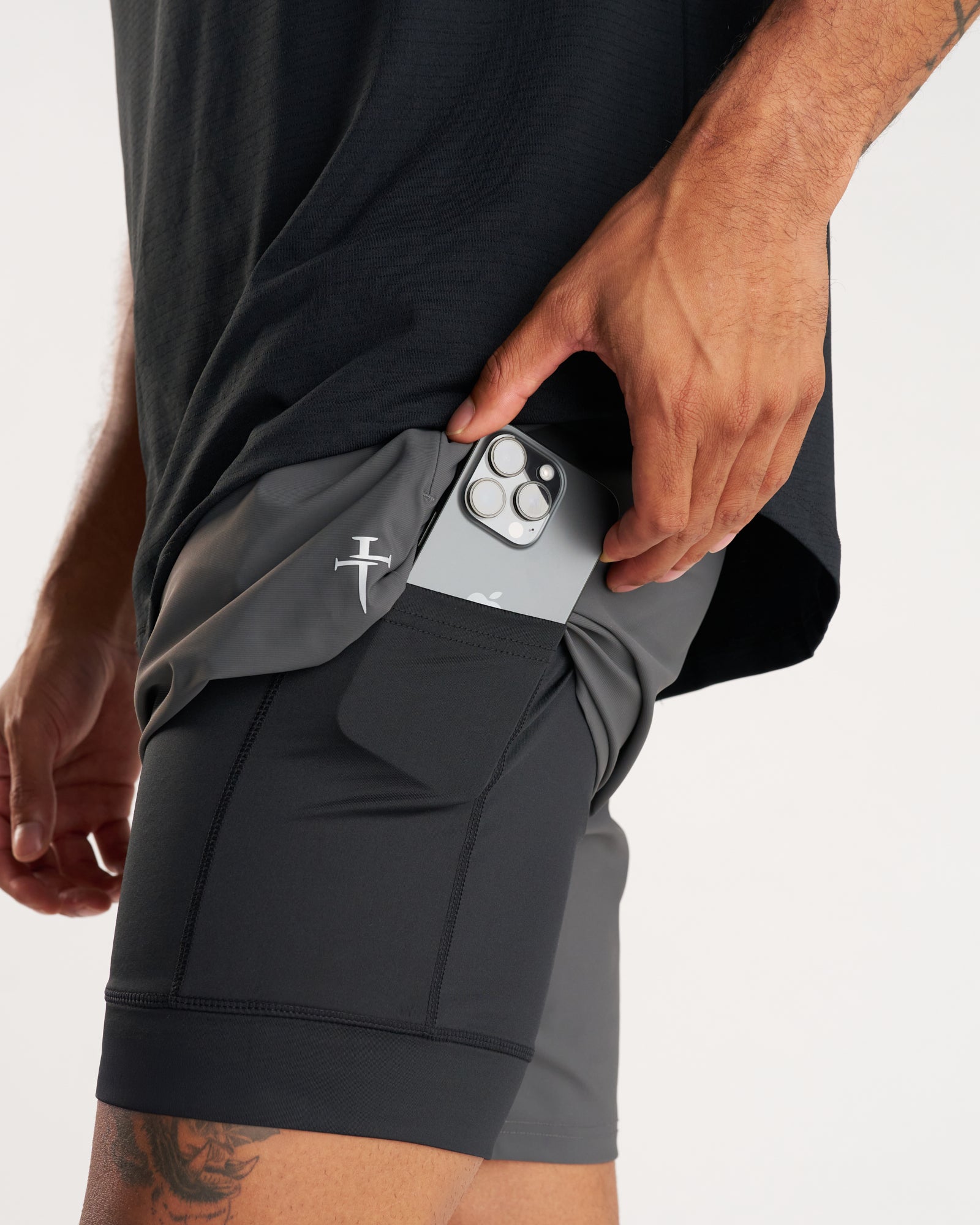 Close-up side view of Space Grey Vapor-Lite Liner Short showing phone being inserted into inner liner pocket.