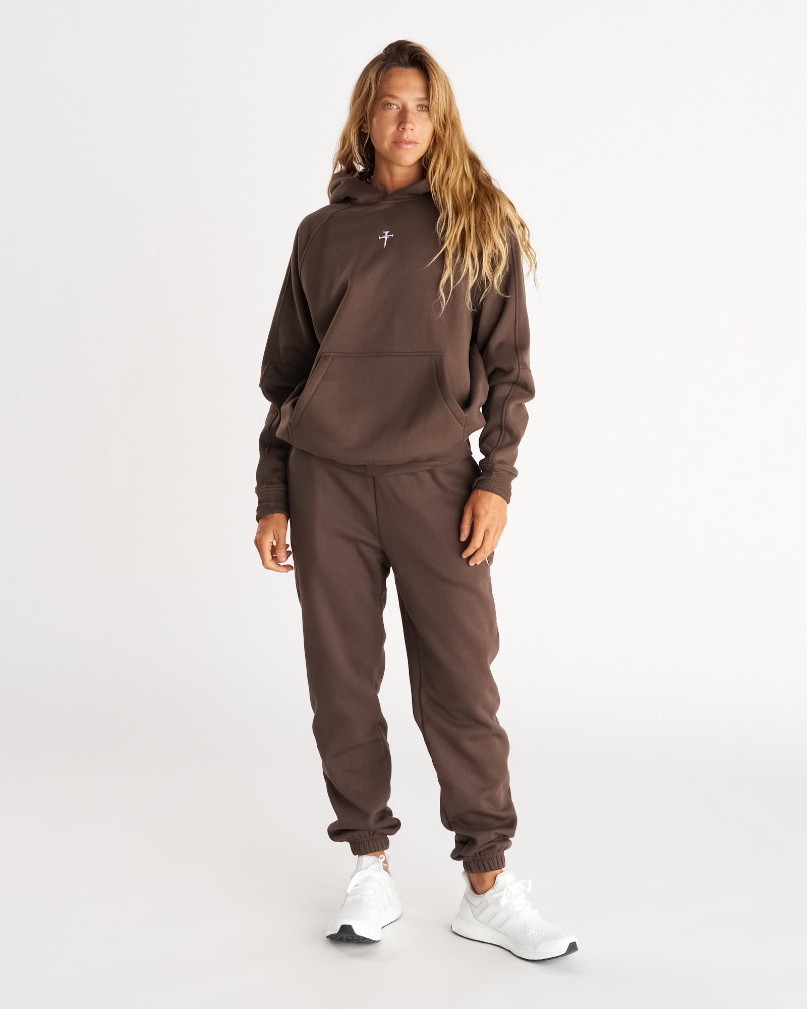 Front view of Signature Fleece Sweatpants in Woodland Brown worn with matching hoodie and white sneakers.