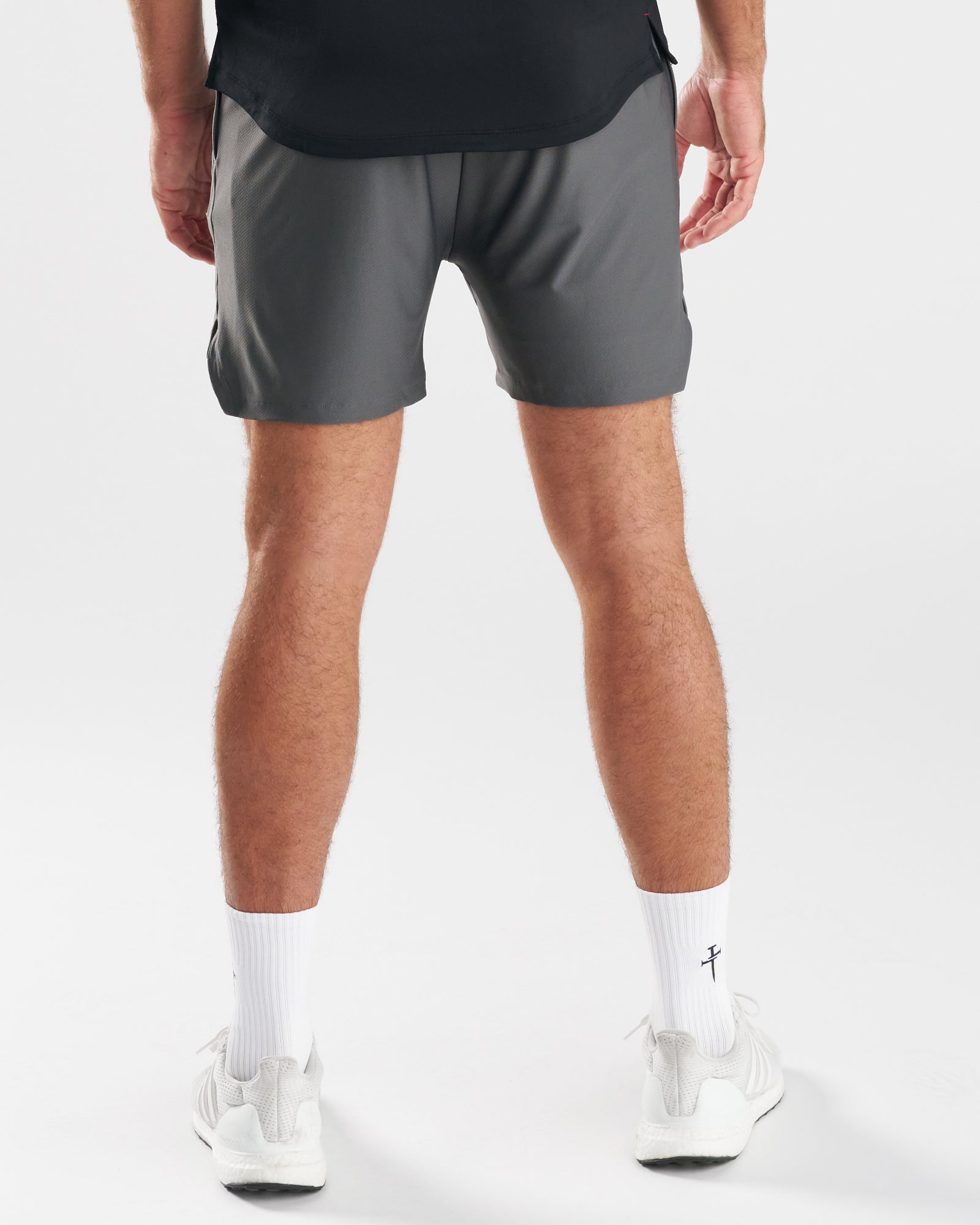 Back view of a model wearing the Pro-Tech 2.0 Liner Short in Space Grey with white sneakers and socks.
