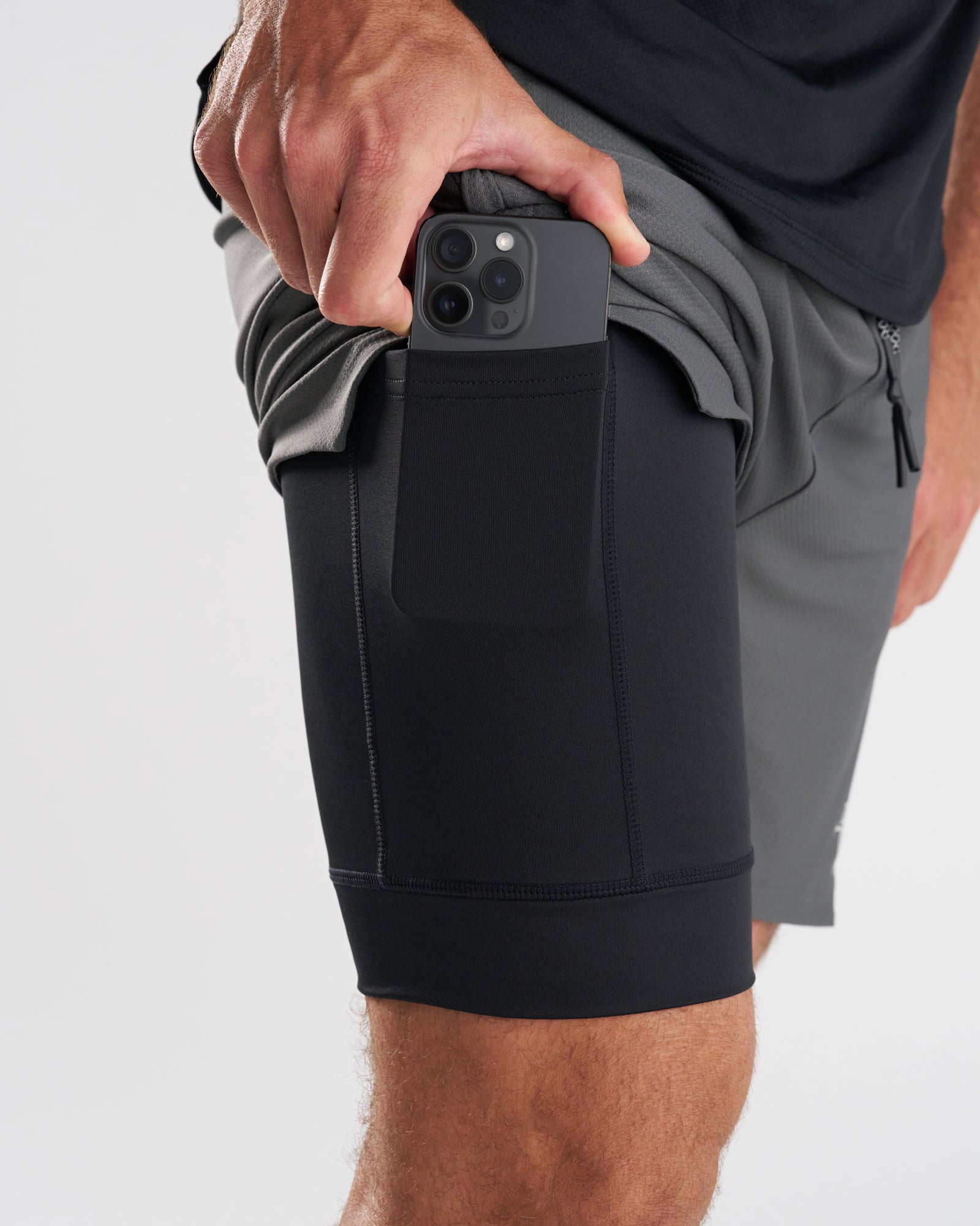Close-up of Pro-Tech 2.0 Liner Short in Space Grey showing a phone being inserted into the black inner liner pocket.