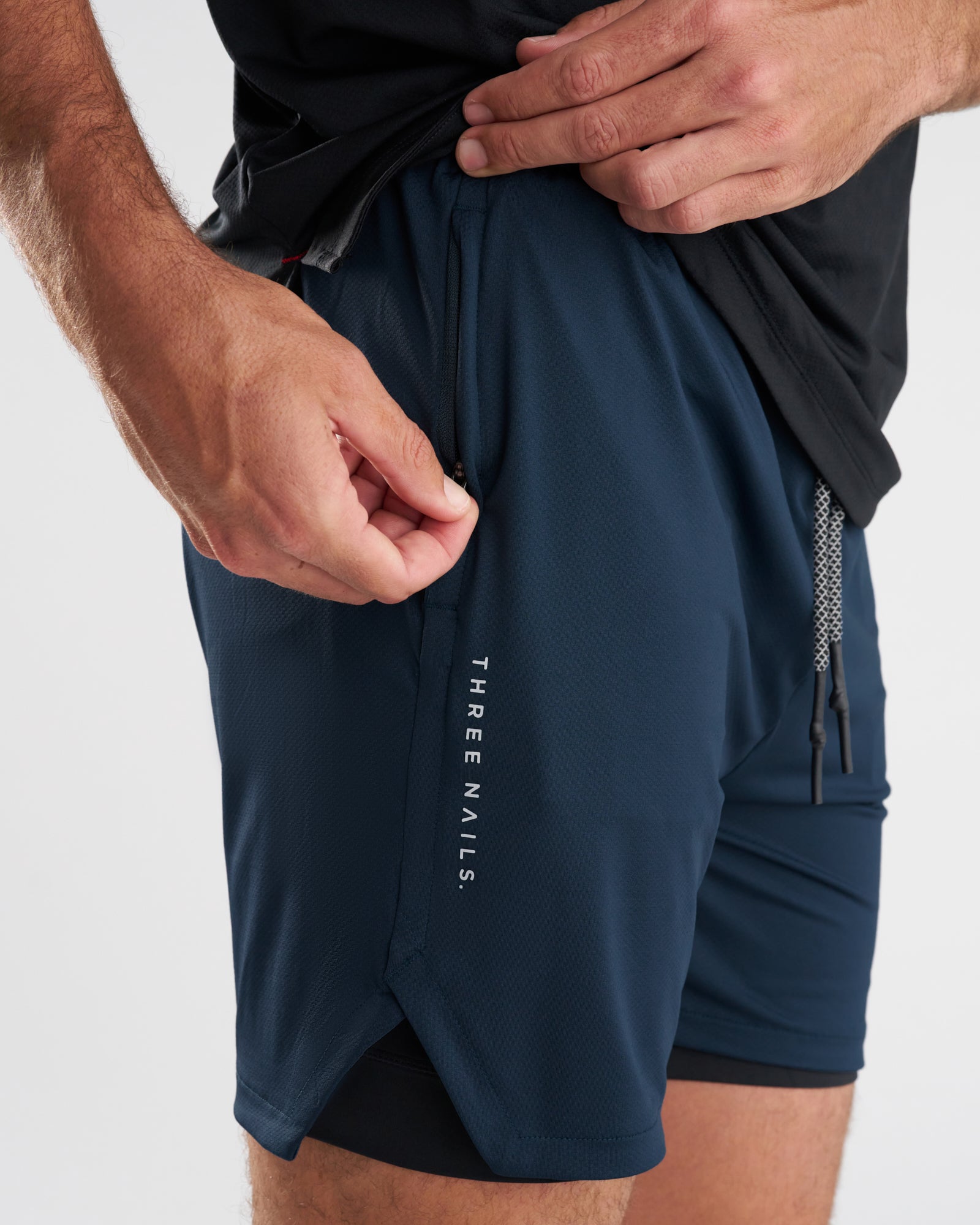 Close-up side view of Pro-Tech 2.0 Liner Short in Midnight Navy showing zippered side pocket detail.