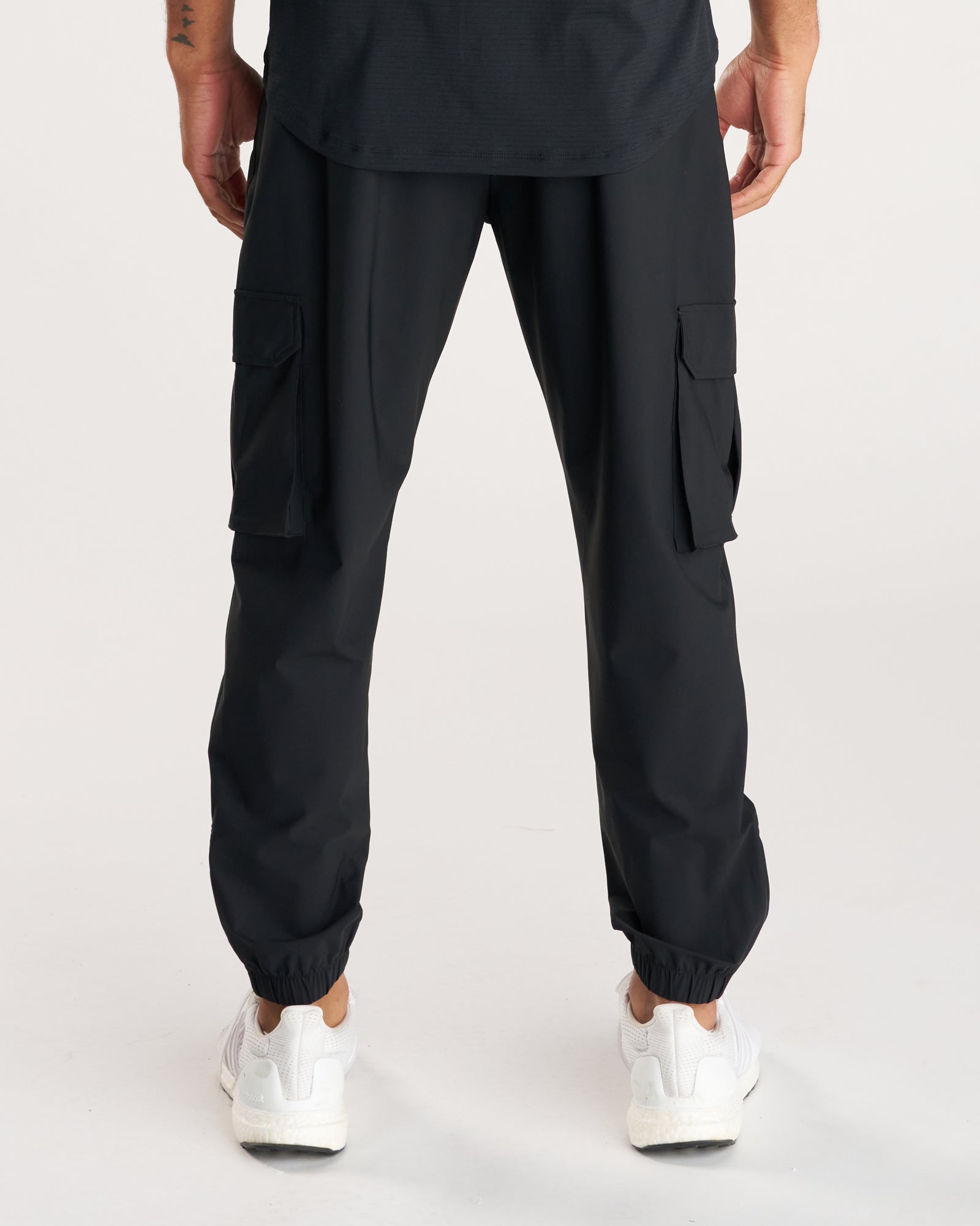 Back view of the Vapor-Lite Cargo Jogger in black, showing dual cargo pockets and elastic cuffs.