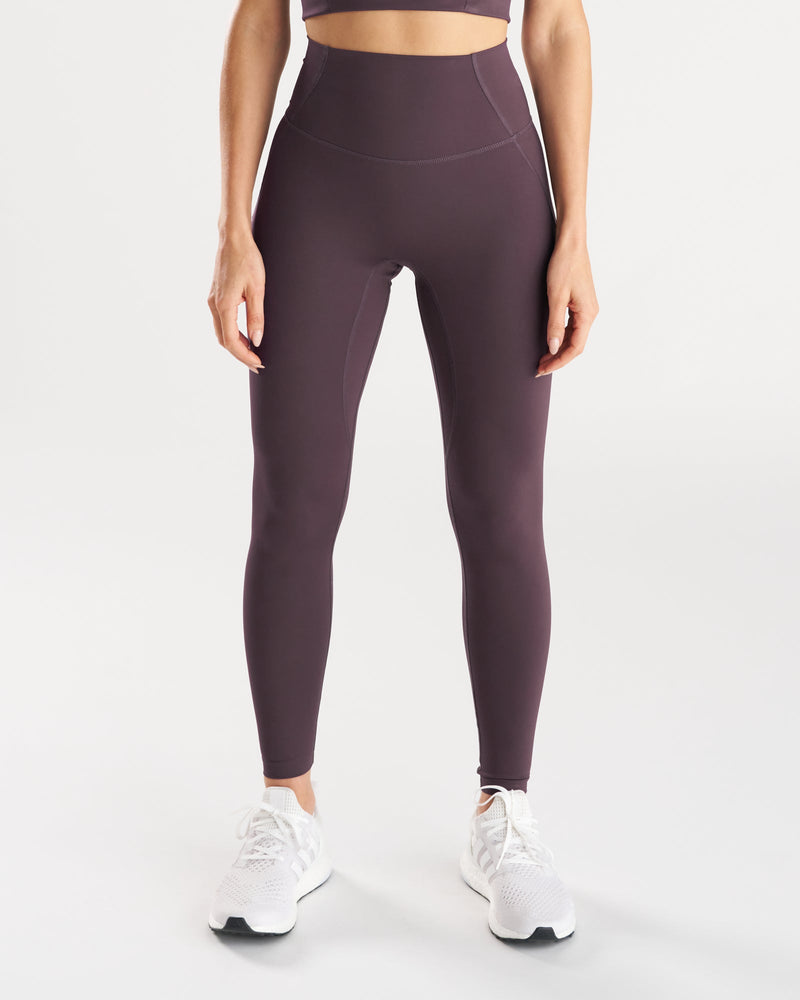 Front view of Endura-Train™ Legging Bundle Pack in dark plum on a standing model with white sneakers.
