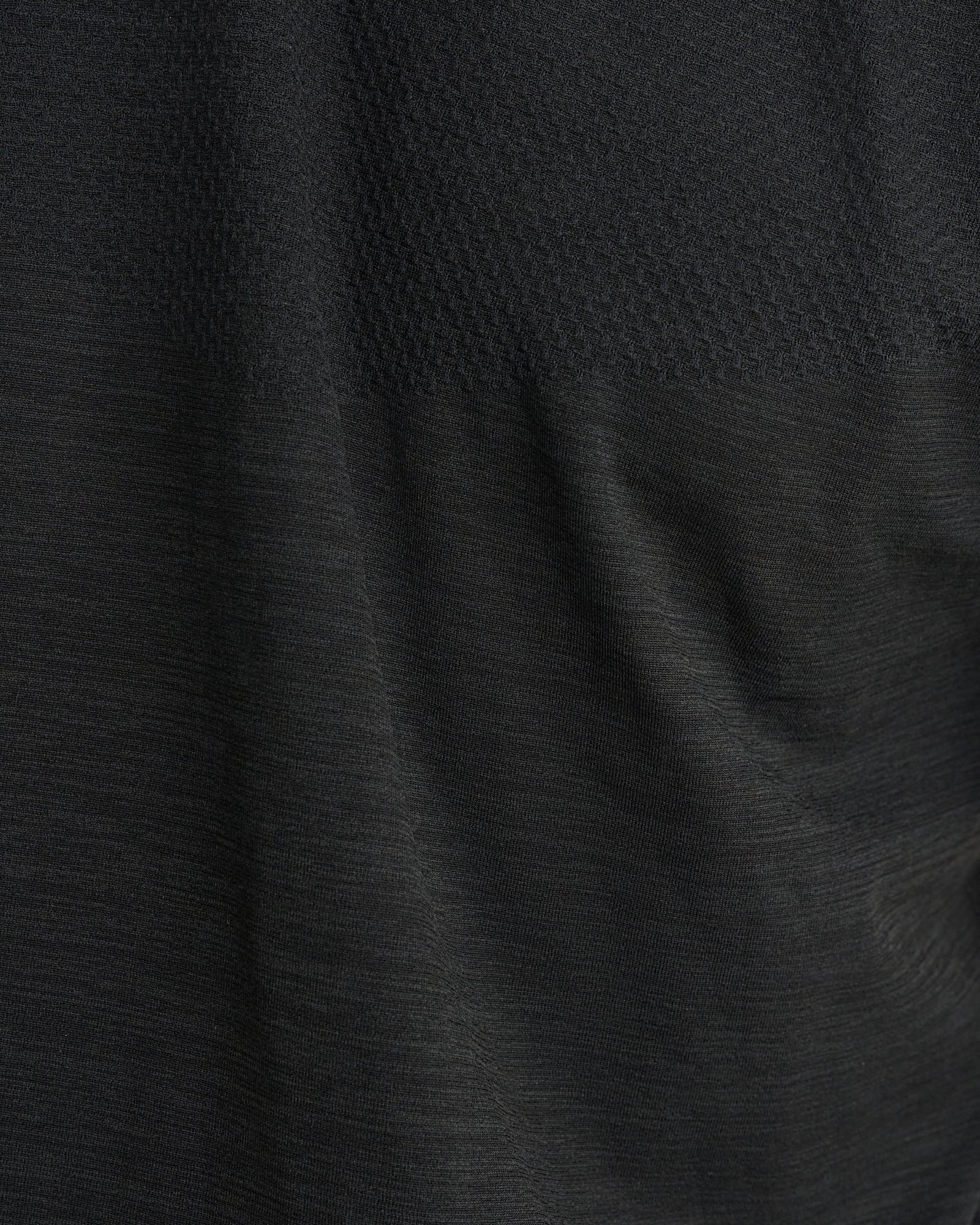 Close-up of Black Marl Seamless Tee fabric texture showing seamless knit and ventilation mesh