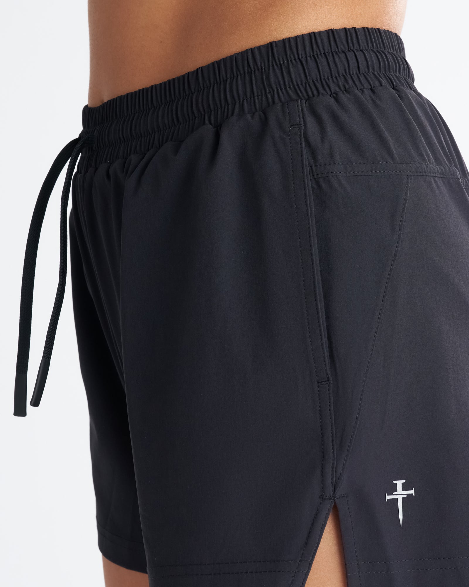 Close-up detail of Women's 3" Pulse Short in Black showing elastic drawstring waistband and small logo.