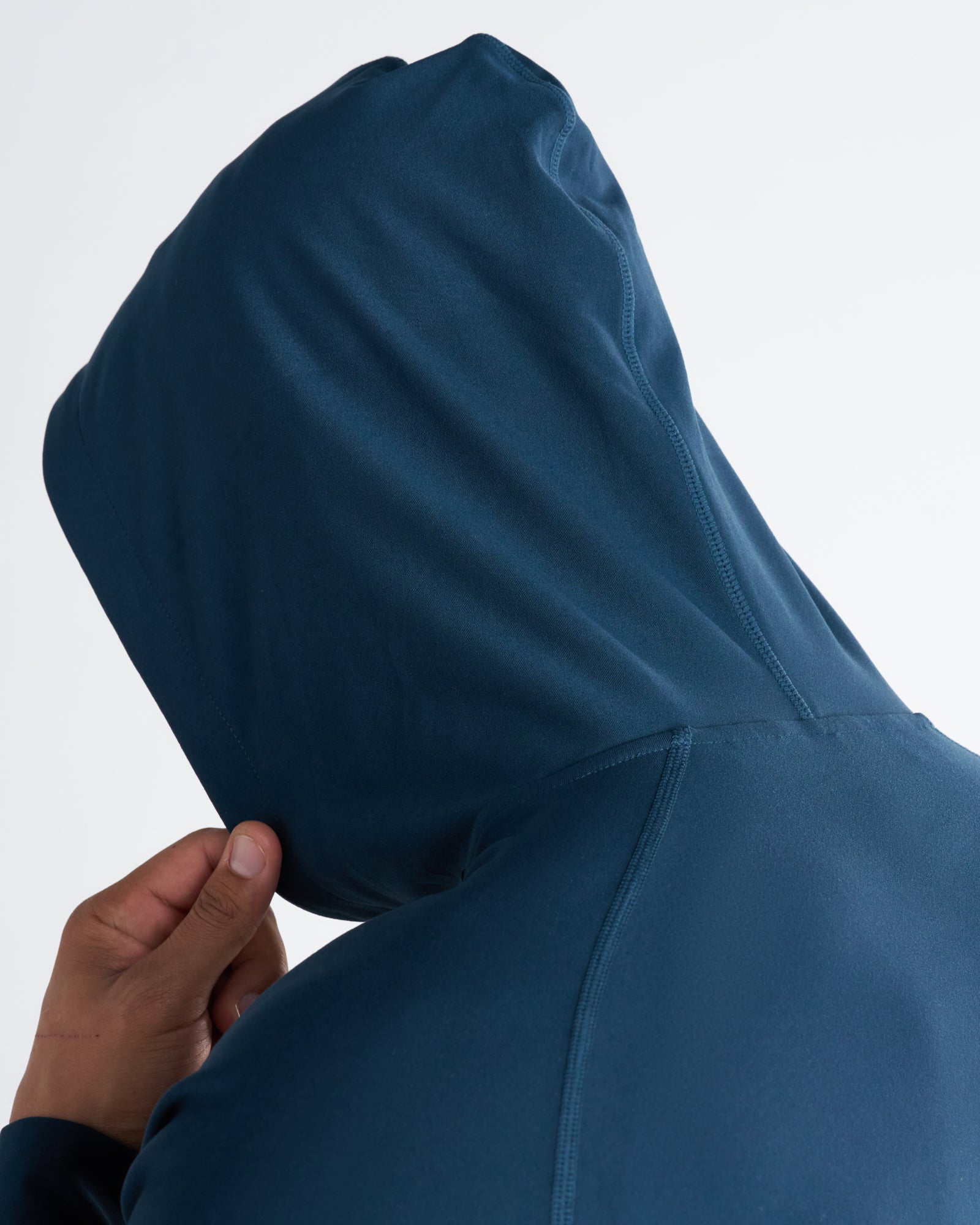 Close-up detail of the Haven Performance Hoodie in Midnight Navy showing the hood structure from a back angle.