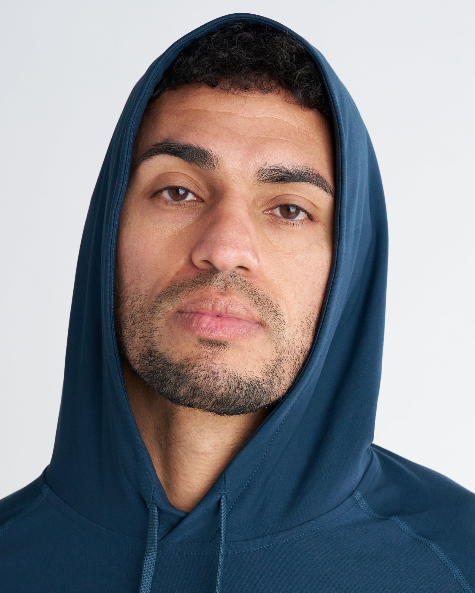 Close-up front view of the Haven Performance Hoodie in Midnight Navy showing hood fit and fabric detail.