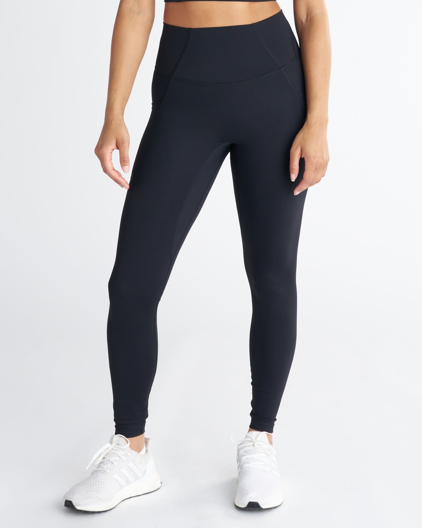 Endura-Train Pocket Legging in black, front view on model showing high waistband and side pocket detail.