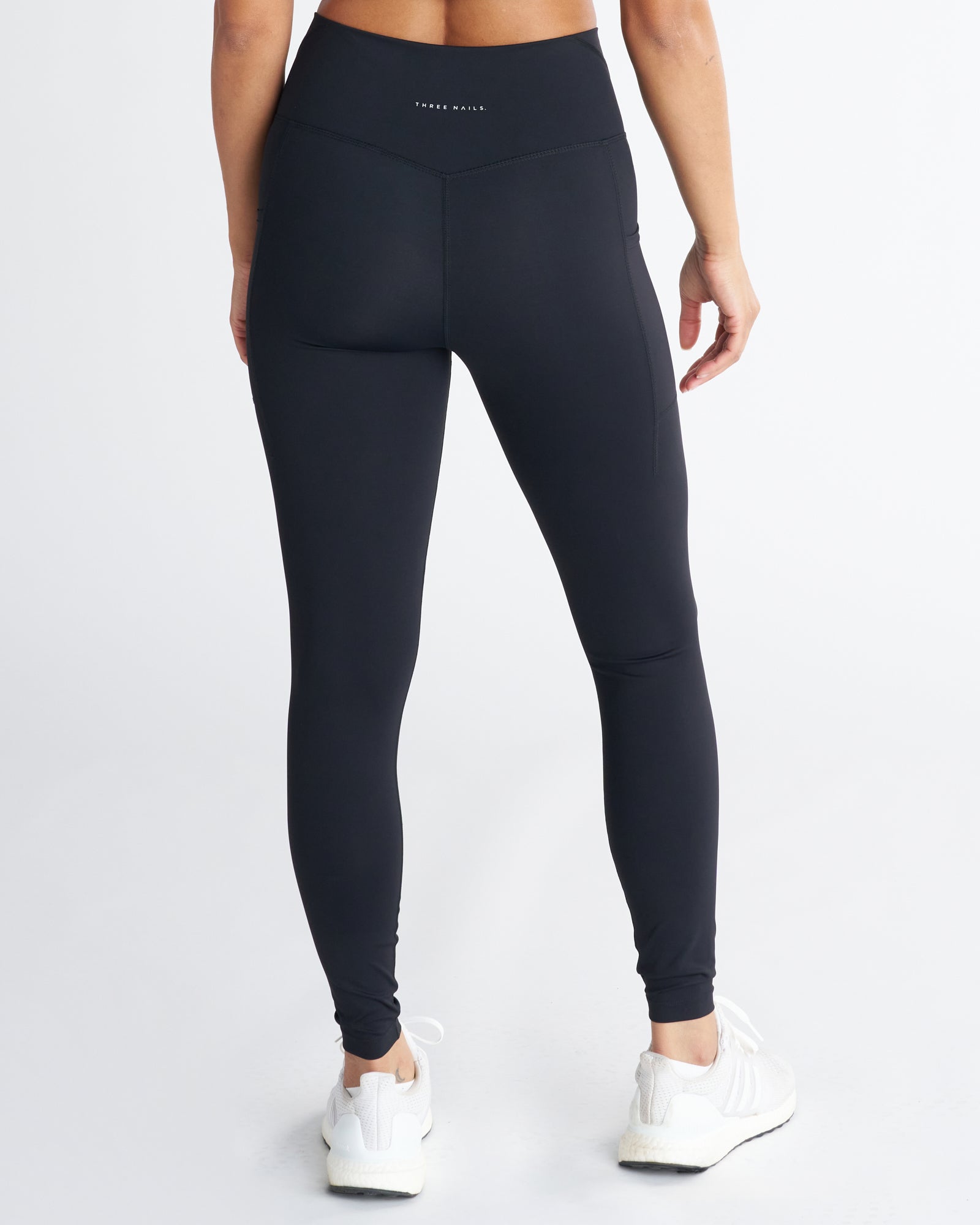 Endura-Train Pocket Legging in black, back view on model showing V-waistband, side pockets, and ankle cuffs.