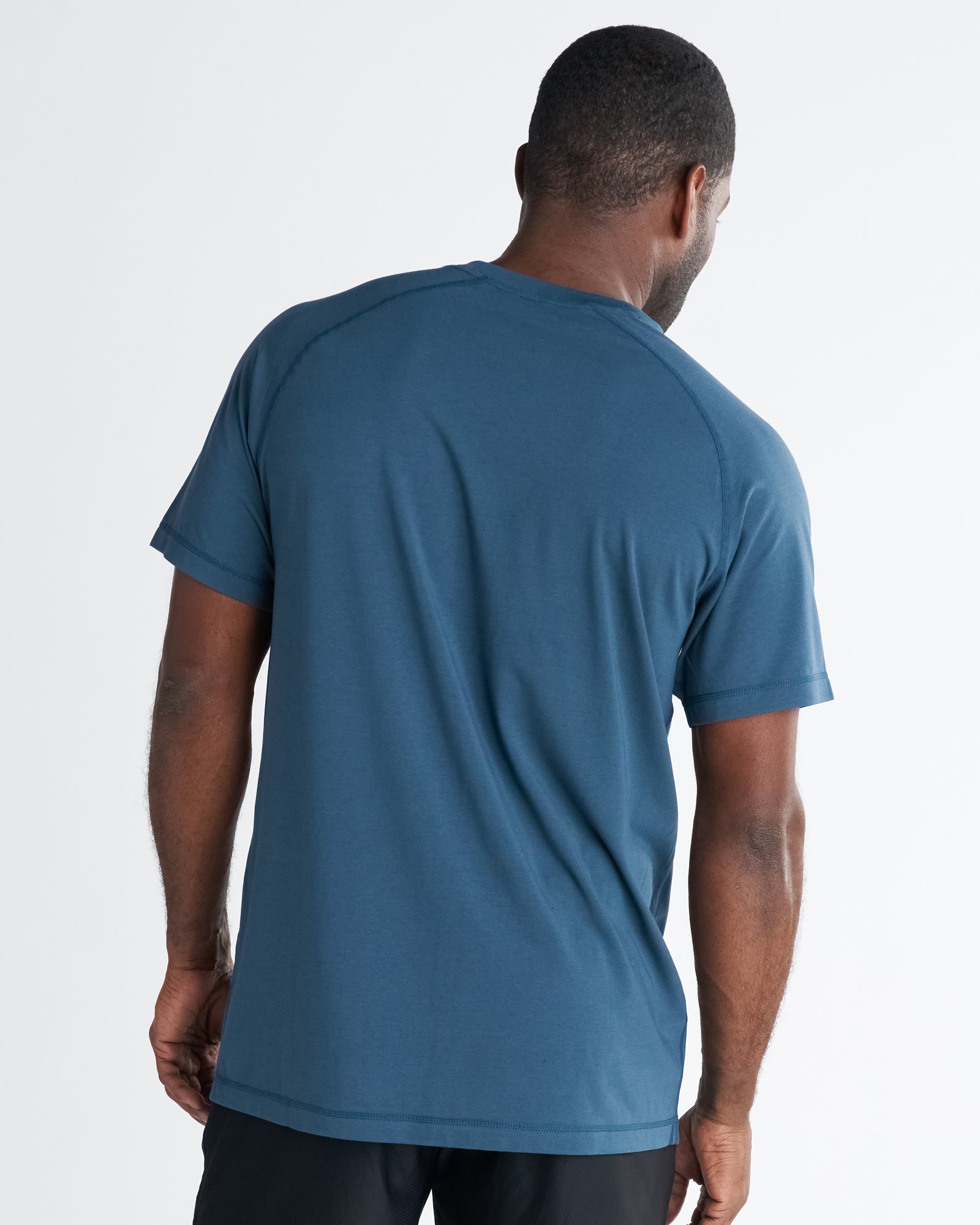 Back view of the Core Tee in Midnight Navy, a short-sleeve crew neck tee with raglan seams.