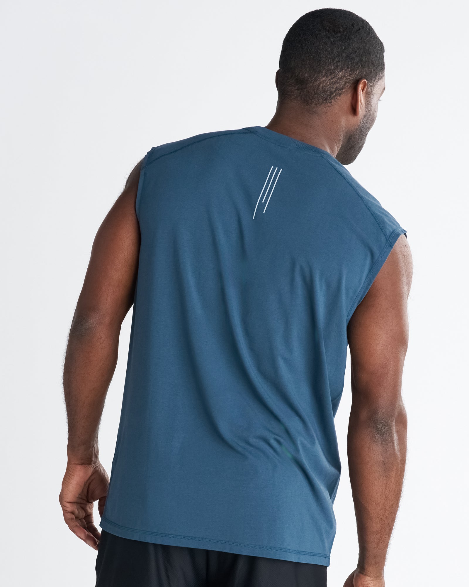 Back view of the Core Raglan Cutoff in Midnight Navy, showing the three-stripe logo detail on the upper back.