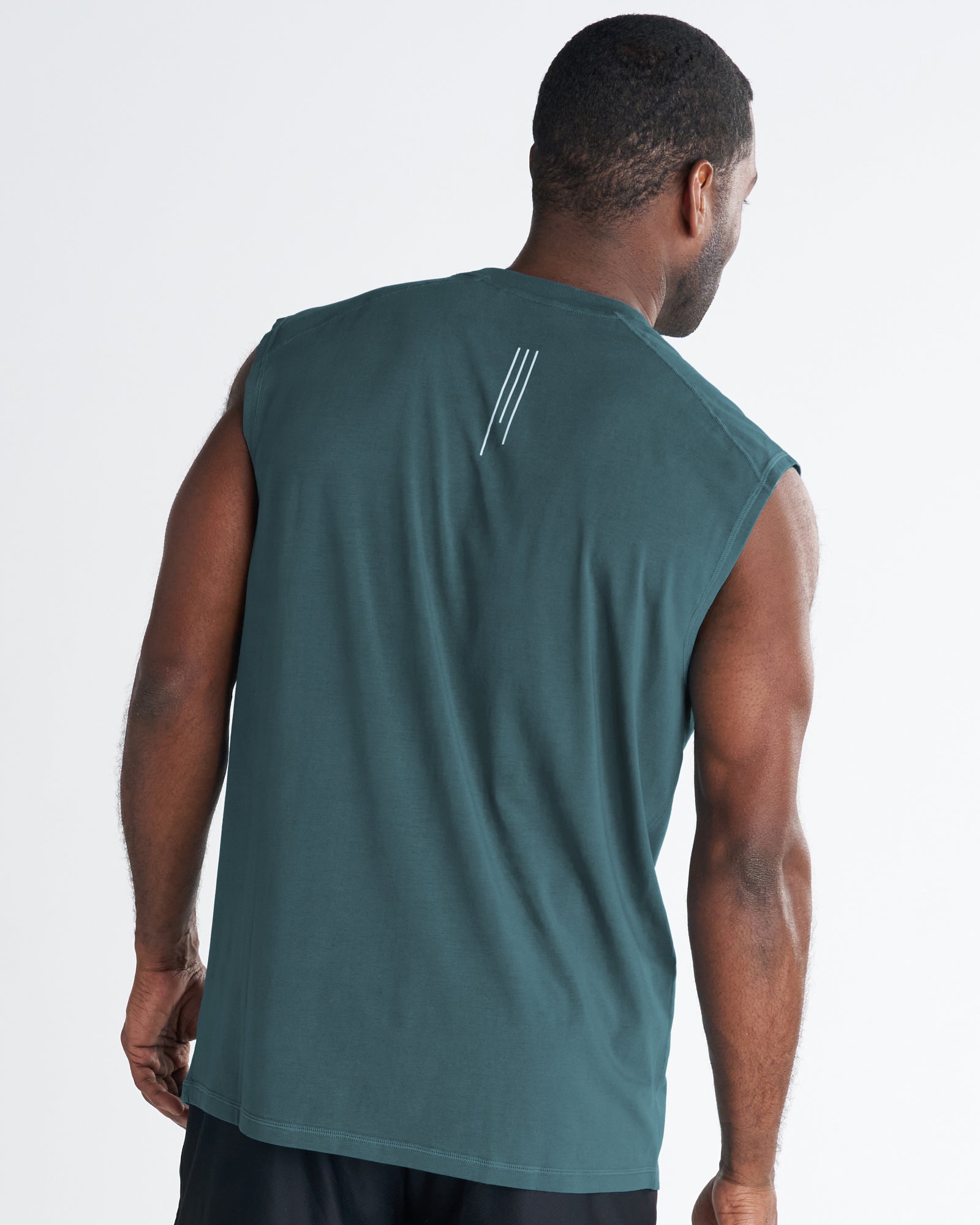 Back view of the Core Raglan Cutoff in teal, showing a small three-stripe logo on upper back.