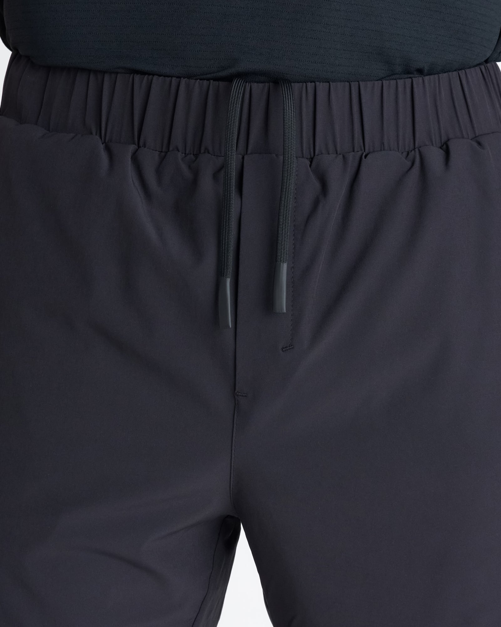Close-up of Pulse Tech Liner Short in Black showing elastic waistband, drawstring with cord tips, and clean front panel.