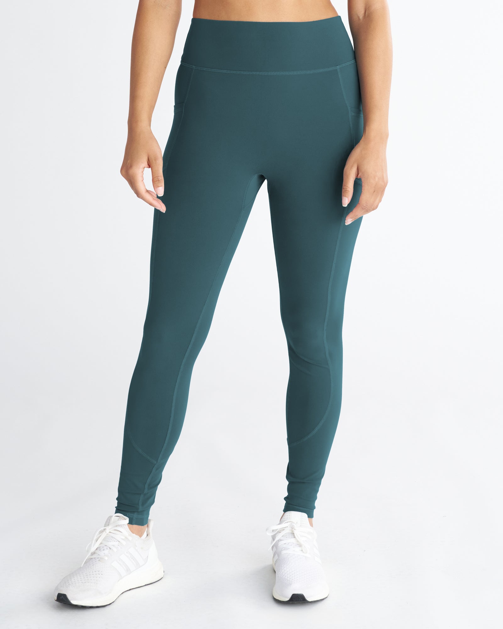 Nova Pocket Legging 27" in teal on a model, front view, showing high waistband and side pockets.