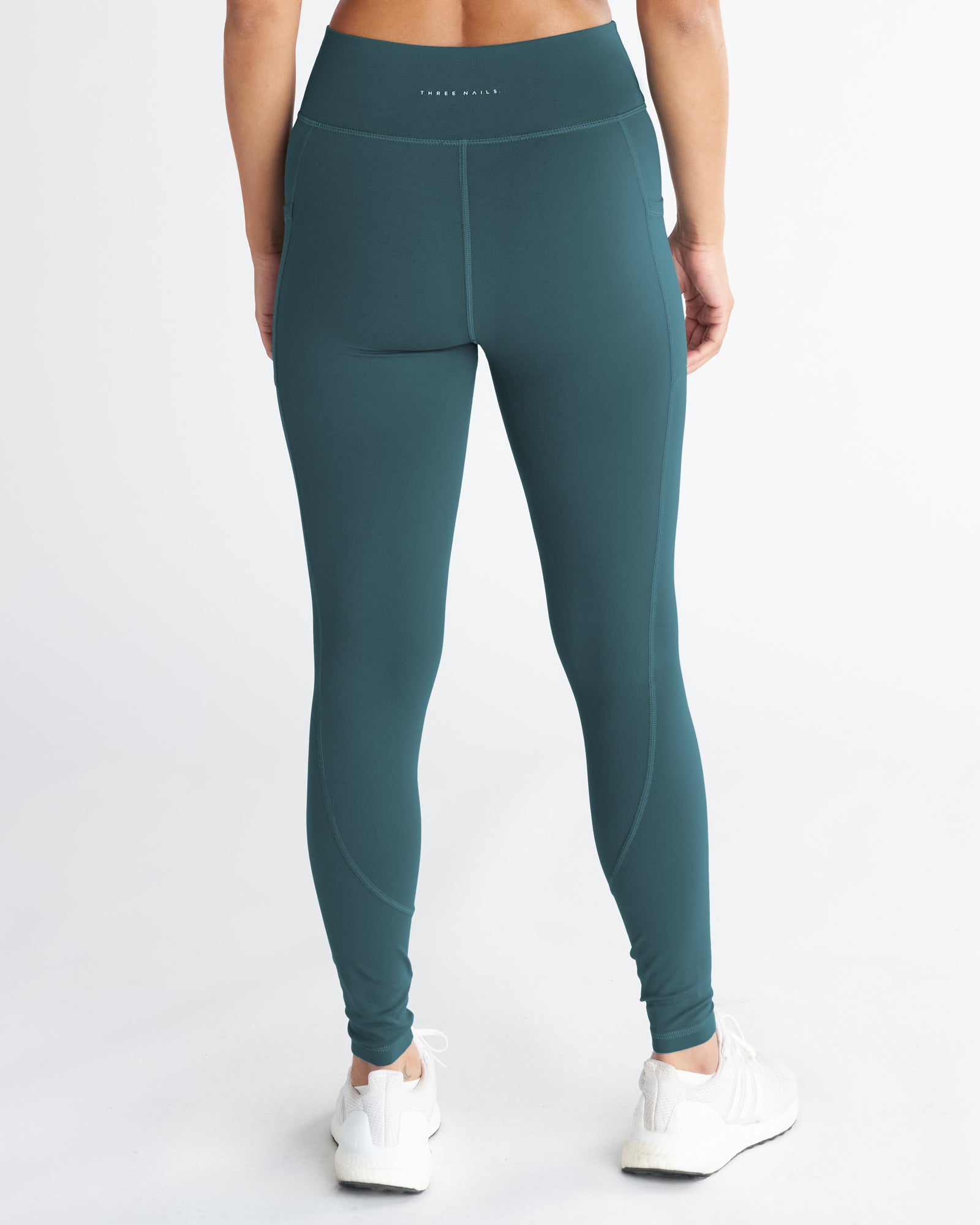 Nova Pocket Legging 27" in Teal, back view on a model showing side pockets and high waistband.
