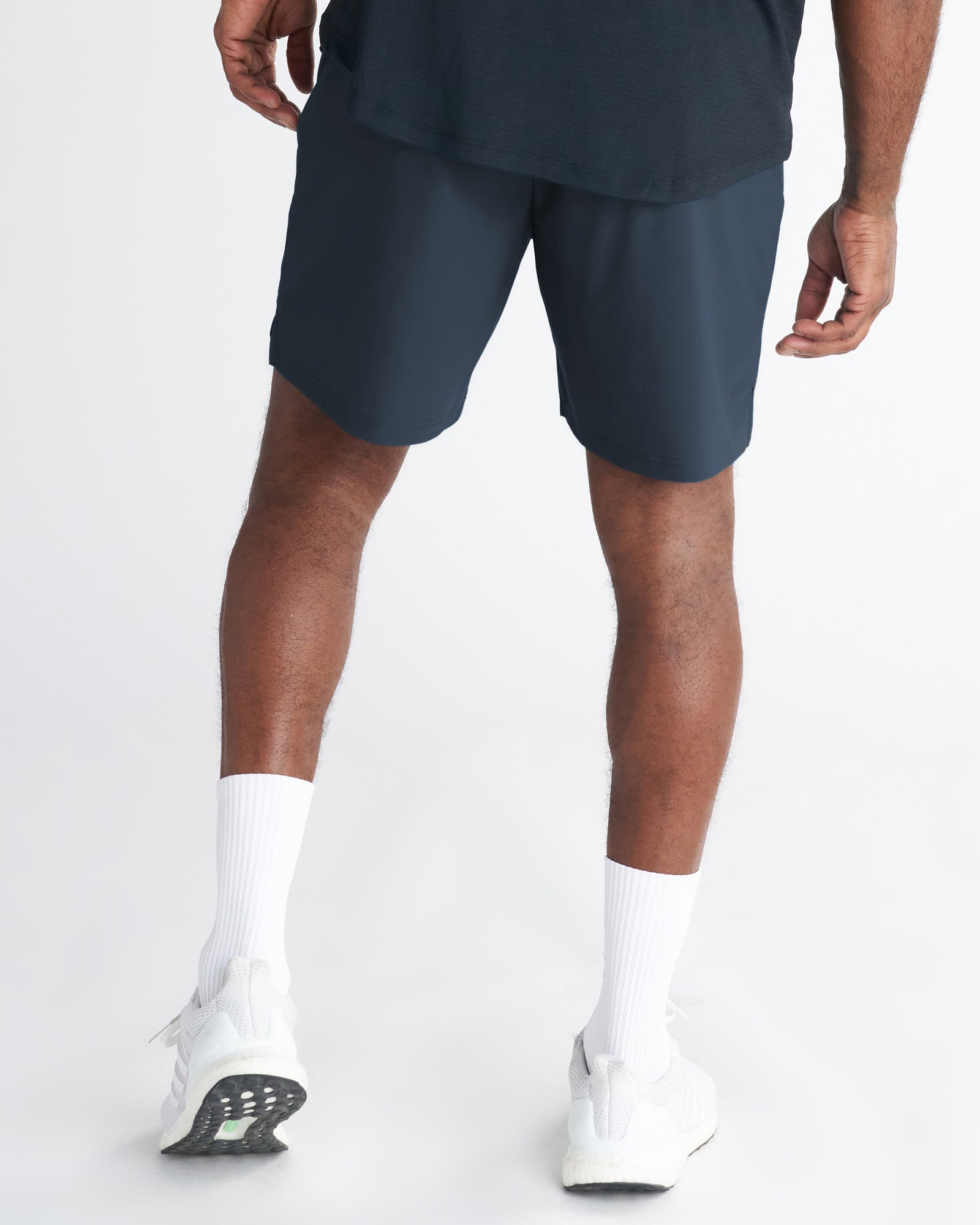 Back view of Vapor-Lite Liner Short Cross in Midnight Navy worn with white sneakers and socks.
