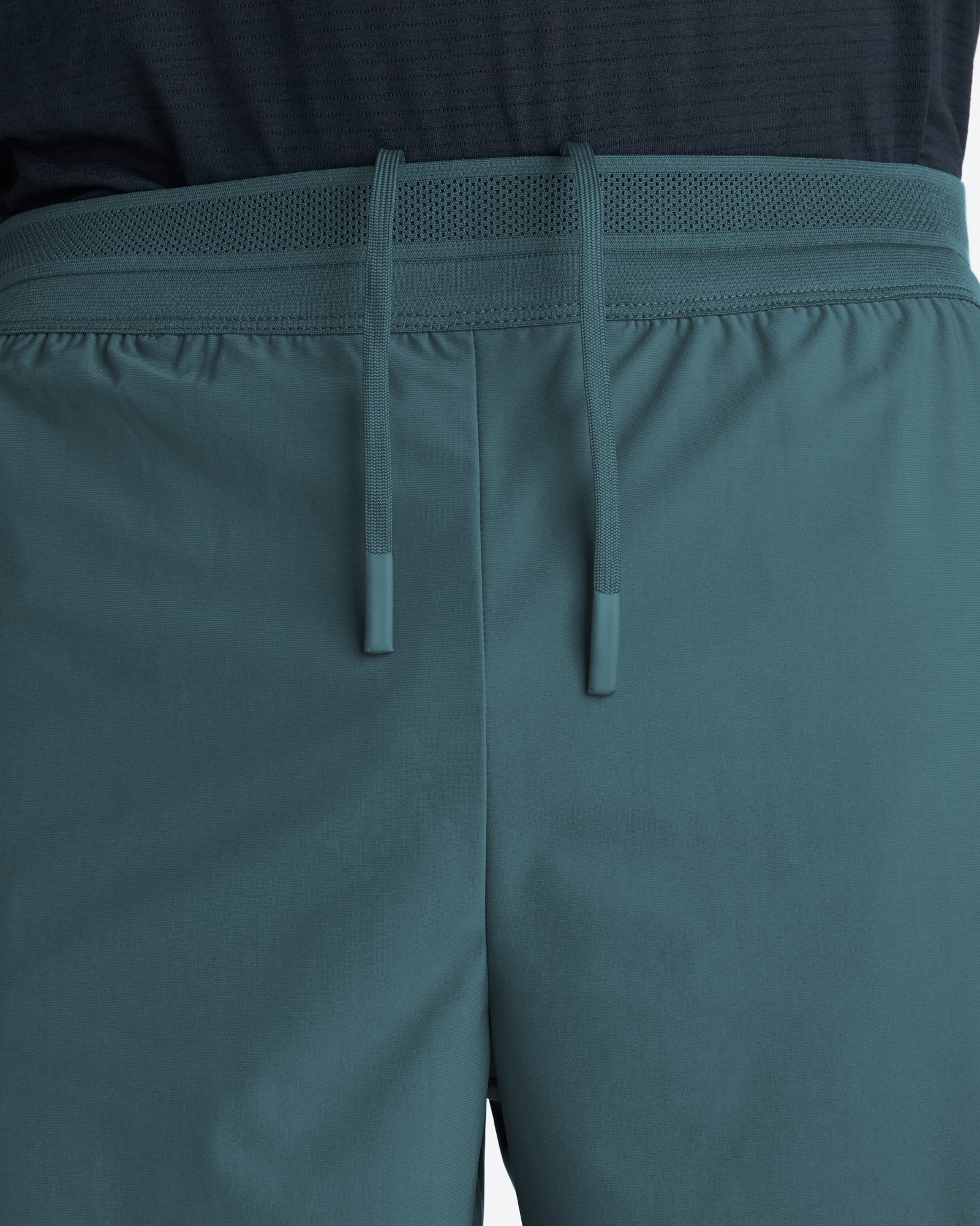 Close-up of the waistband and drawcord detail on the Vapor-Lite Liner Short Cross in Teal.