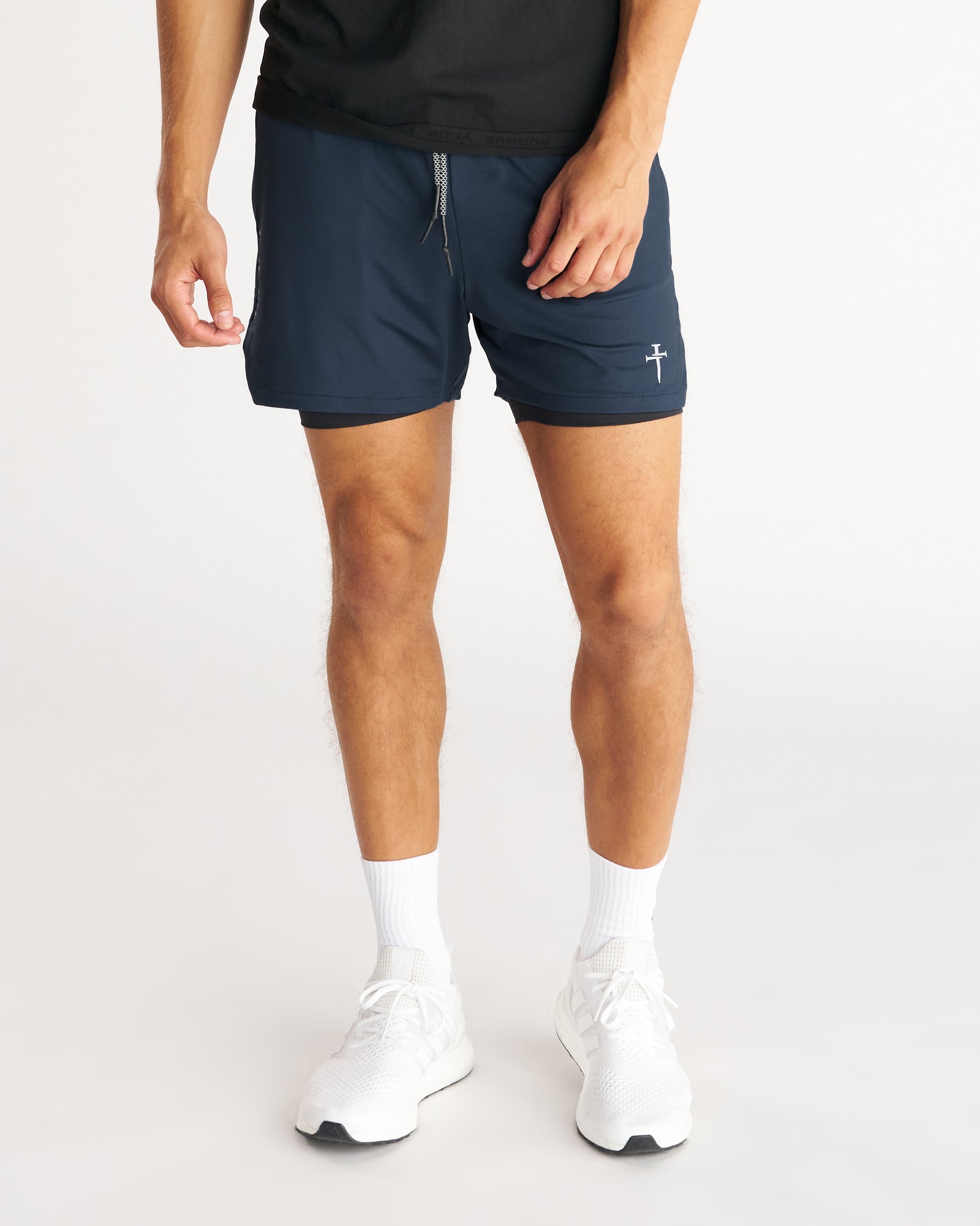 Front view of Pro-Tech 2.0 Liner 5" Short Bundle Pack in navy worn by male model with white sneakers.