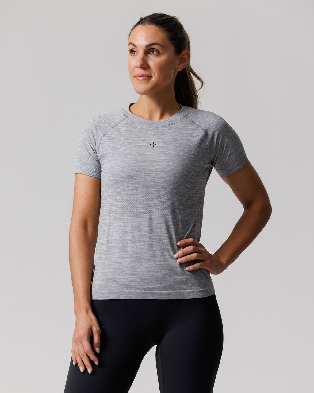 Women's Seamless Tee Cross in Grey Marl, front view on a model with one hand on hip.