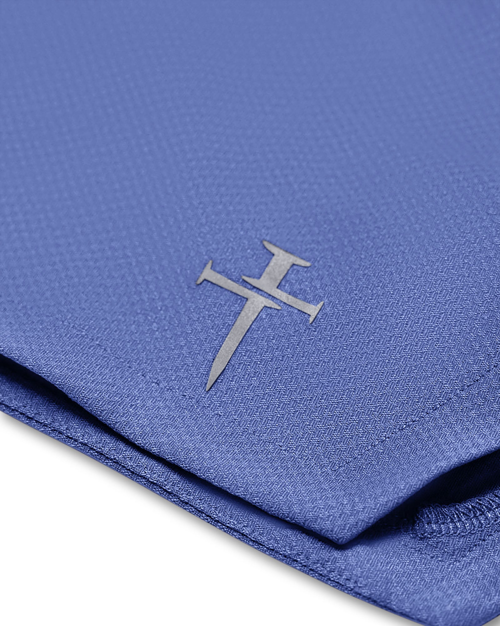 Close-up of the Three Nails logo on the Serene Blue Pro-Tech 2.0 Linerless Short fabric.
