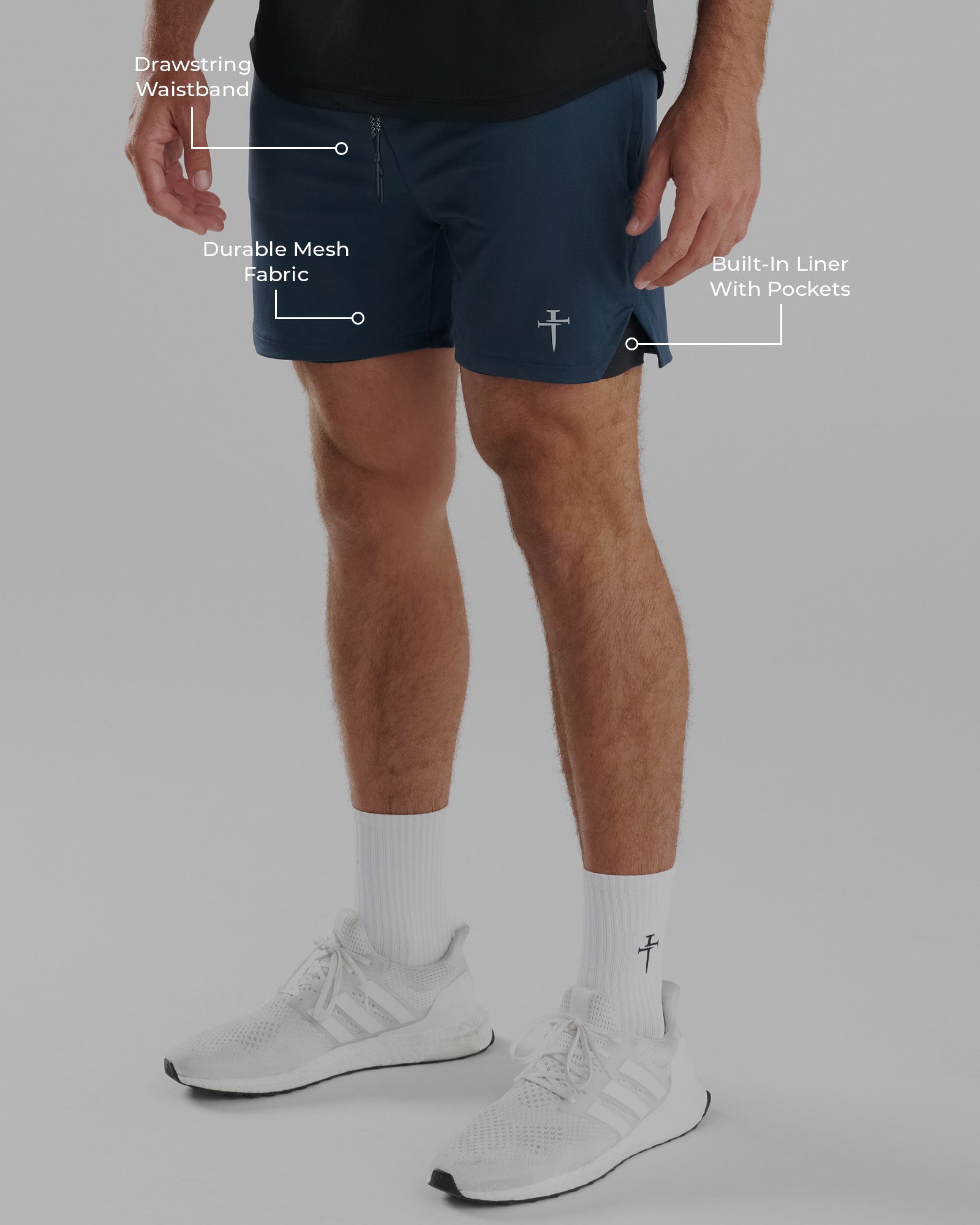 Pro-Tech 2.0 Liner Short in Midnight Navy on a male model at a side angle with feature callouts.