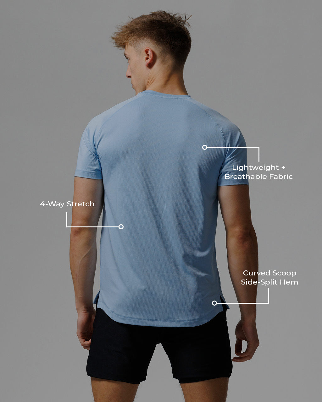 Back view of a male model wearing the Pro-Tech Tee Cross in sky blue, showing curved hem and side splits.