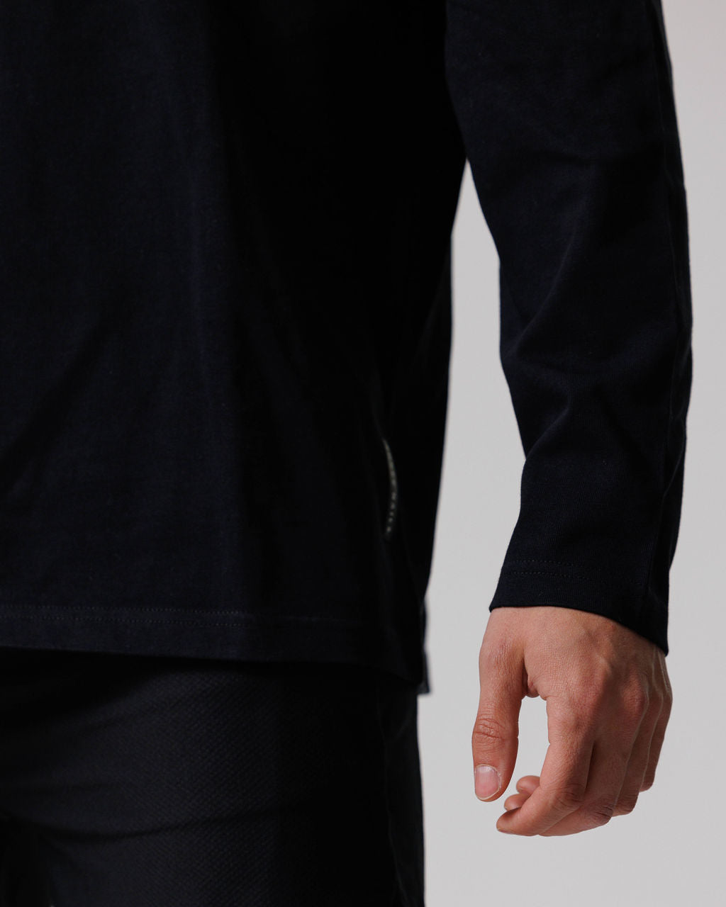 Close-up detail of the Black Heavyweight Cotton Oversized Long Sleeve showing the sleeve hem and relaxed fit at the wrist.