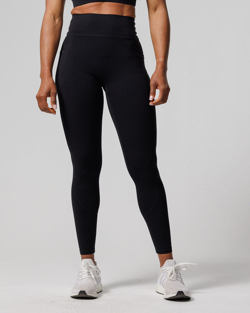 Front view of the Nova Pocket Legging 27" in black on a standing model, showing high waistband and side pockets.