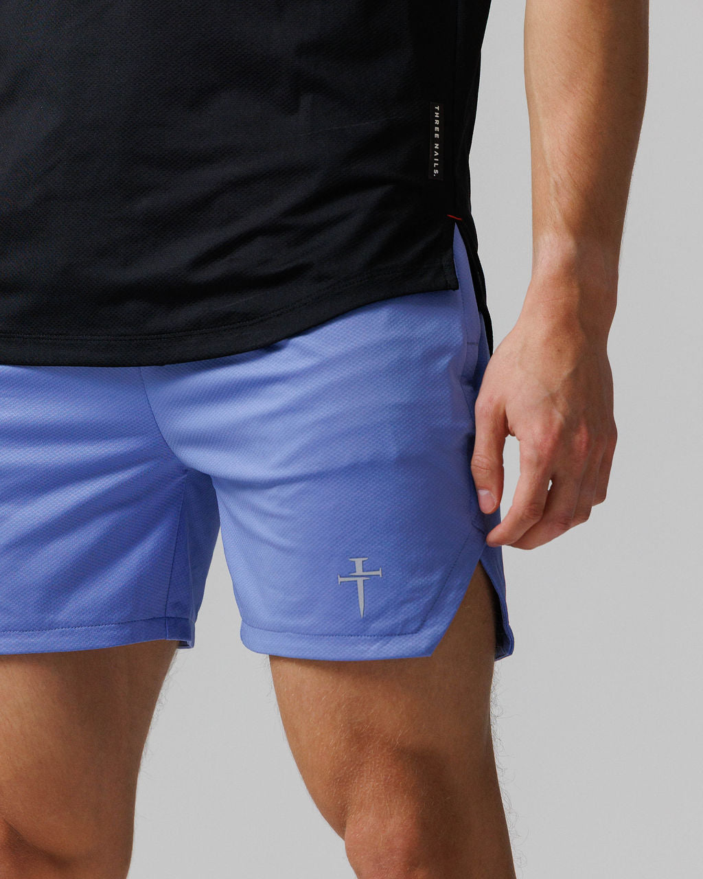 Close-up side angle of Pro-Tech 2.0 Linerless Short in Serene Blue showing logo detail on left leg.