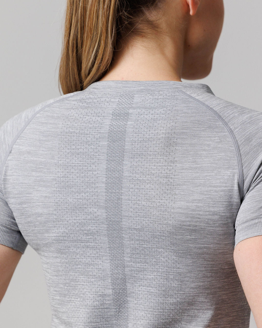 Close-up back view of the Womens Seamless Tee Cross in Grey Marl showing textured spine detail and raglan sleeves.