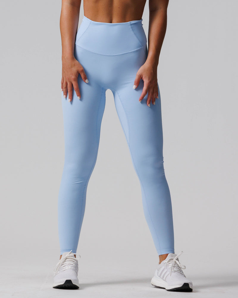 Front view of Endura-Train Legging Bundle Pack in light blue on a standing model with white sneakers.