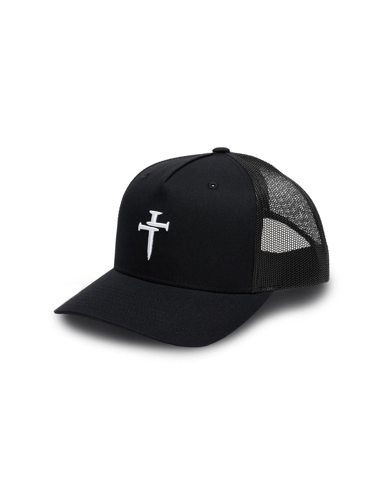 Black Signature Trucker Hat flatlay with white embroidered nail cross logo on structured front panel and mesh back.