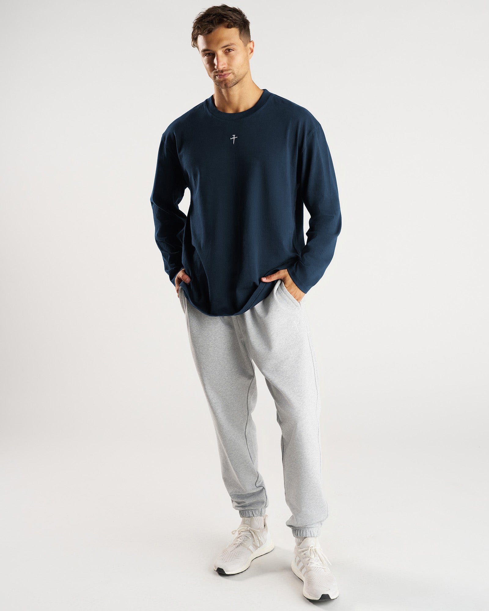 Heavyweight Cotton Oversized Long Sleeve FHG in Midnight Navy, front view on male model paired with grey joggers.
