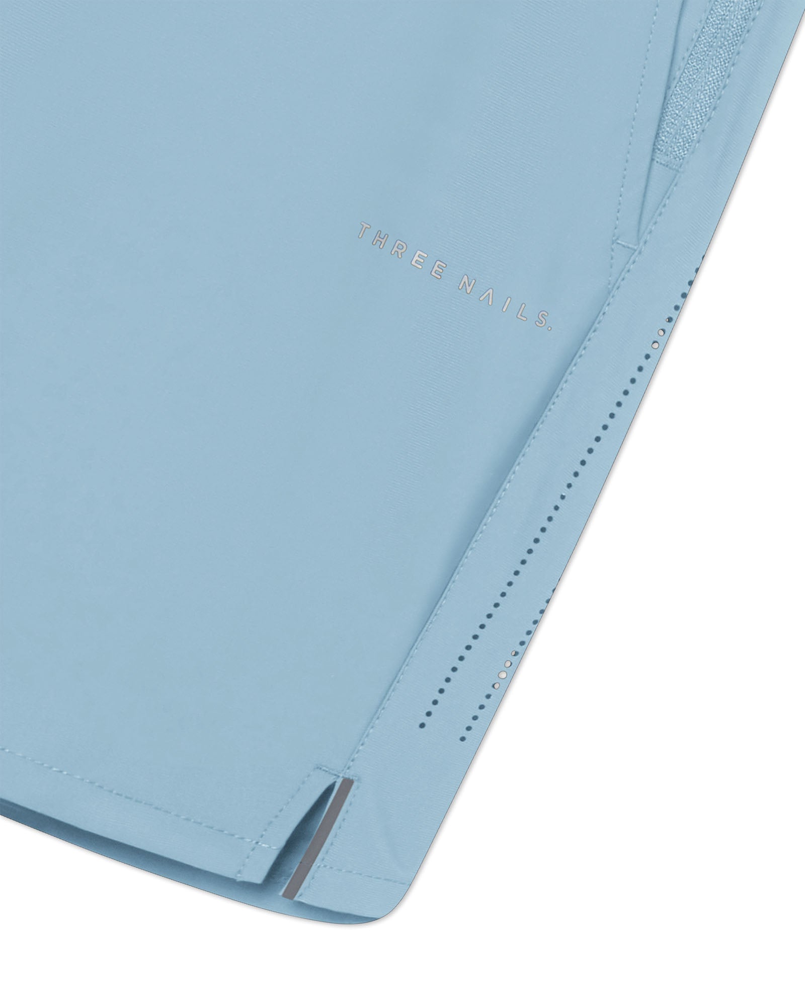 Close-up of Sky Blue Vapor-Lite Hybrid Short showing side vent, perforated detail, and subtle Three Nails logo.