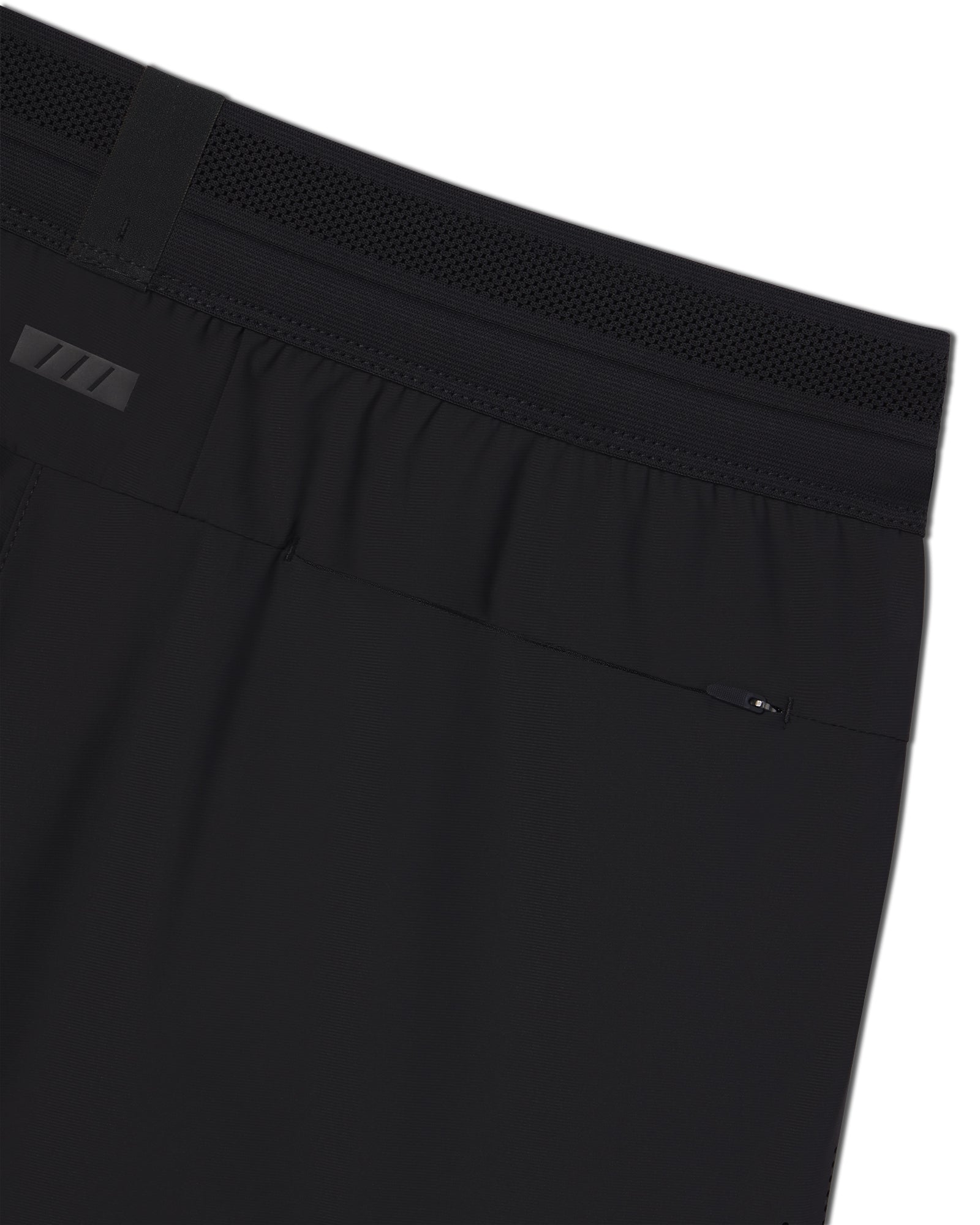 Close-up of the Vapor-Lite Hybrid Short in black showing mesh waistband, zip back pocket, and elastic waist detail.