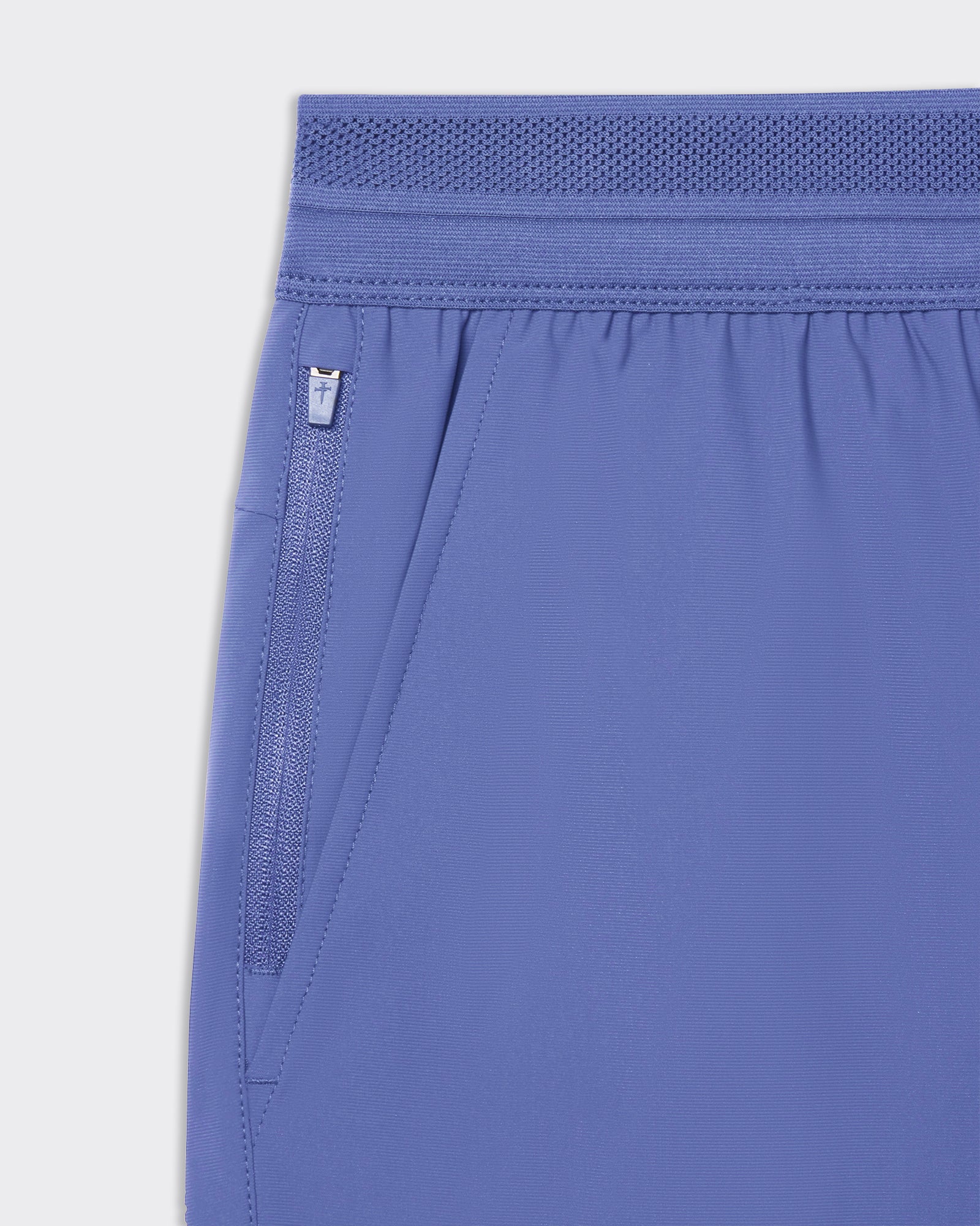 Close-up of Vapor-Lite Hybrid Short in Serene Blue showing zippered side pocket and elastic waistband detail.