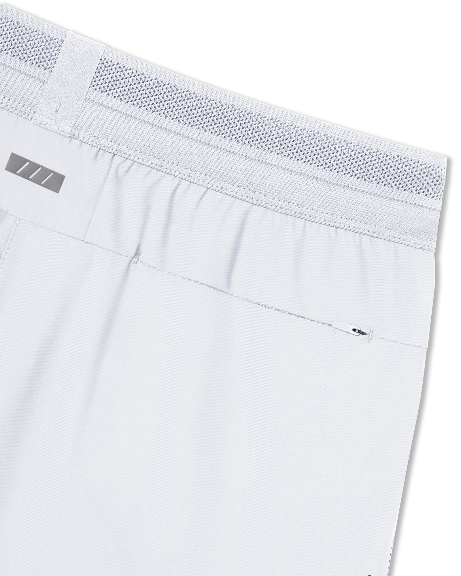 Close-up of Vapor-Lite Hybrid Short in Stone showing mesh waistband, elastic back, and zippered rear pocket.