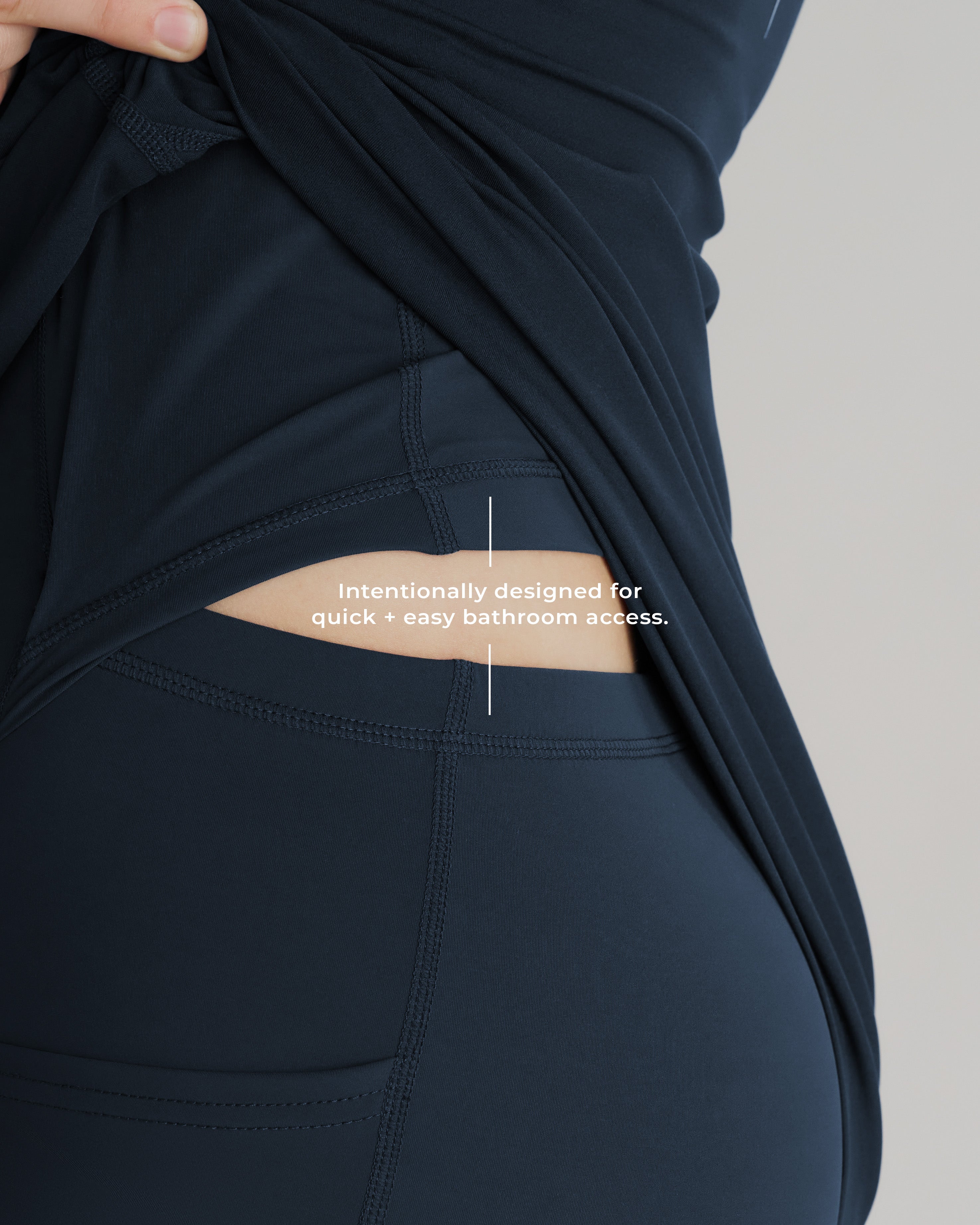 Close-up detail of Links Golf Dress in Midnight Navy showing side opening designed for bathroom access.