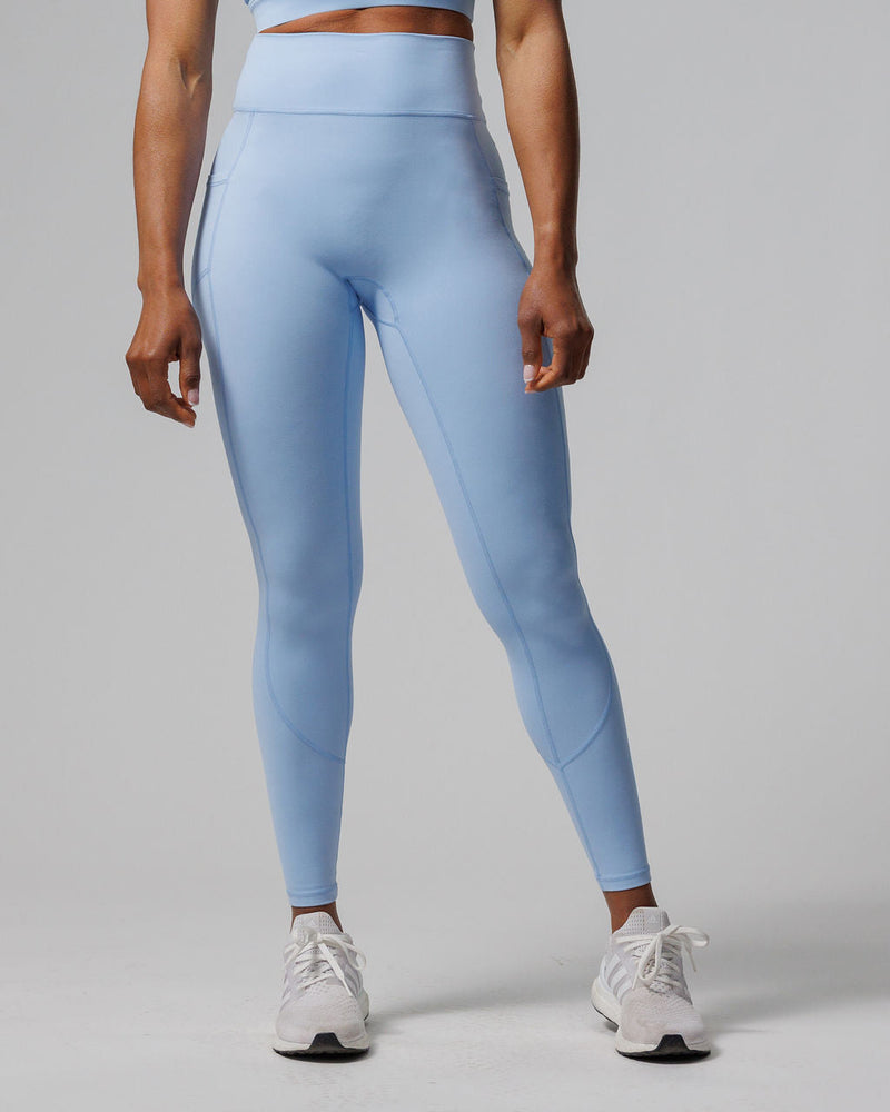 Front view of Nova Pocket Legging 27" in light blue on a standing model showing side pockets and high waistband.