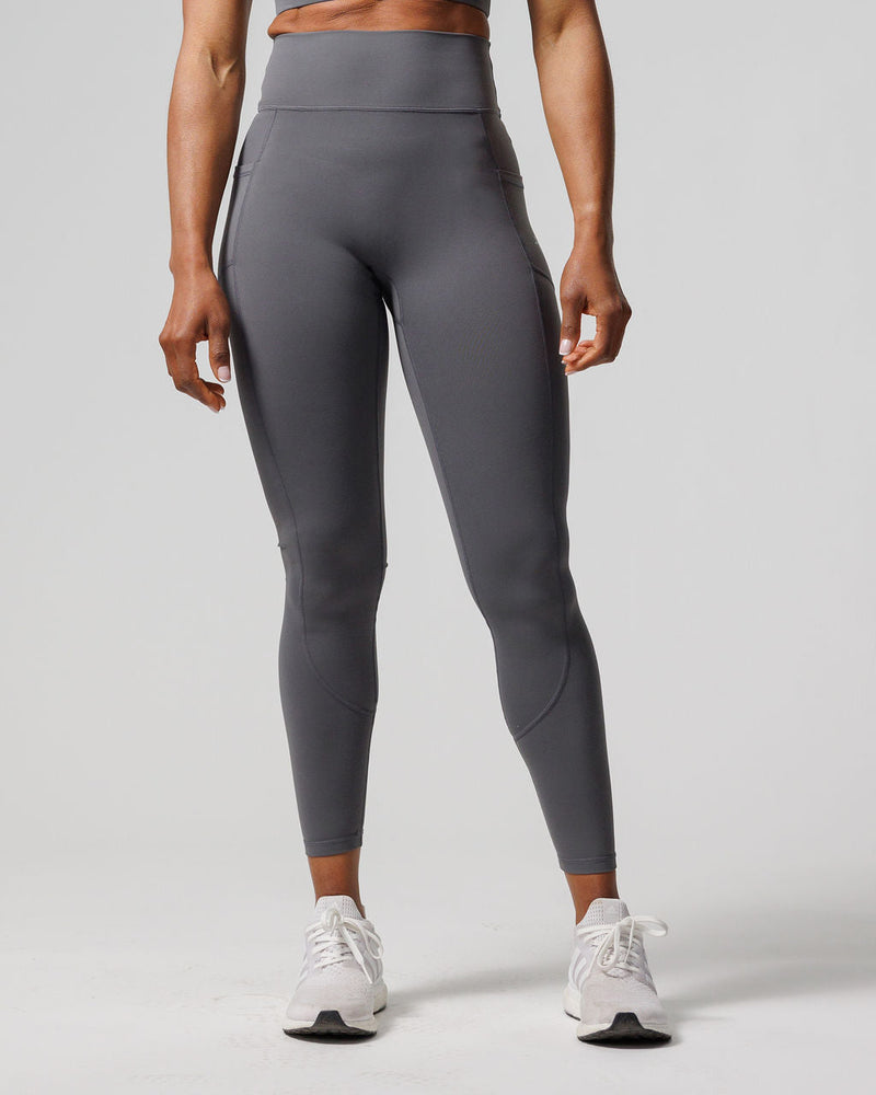Nova Pocket Legging 27" in slate gray, front view on model showing high waistband and side pockets.