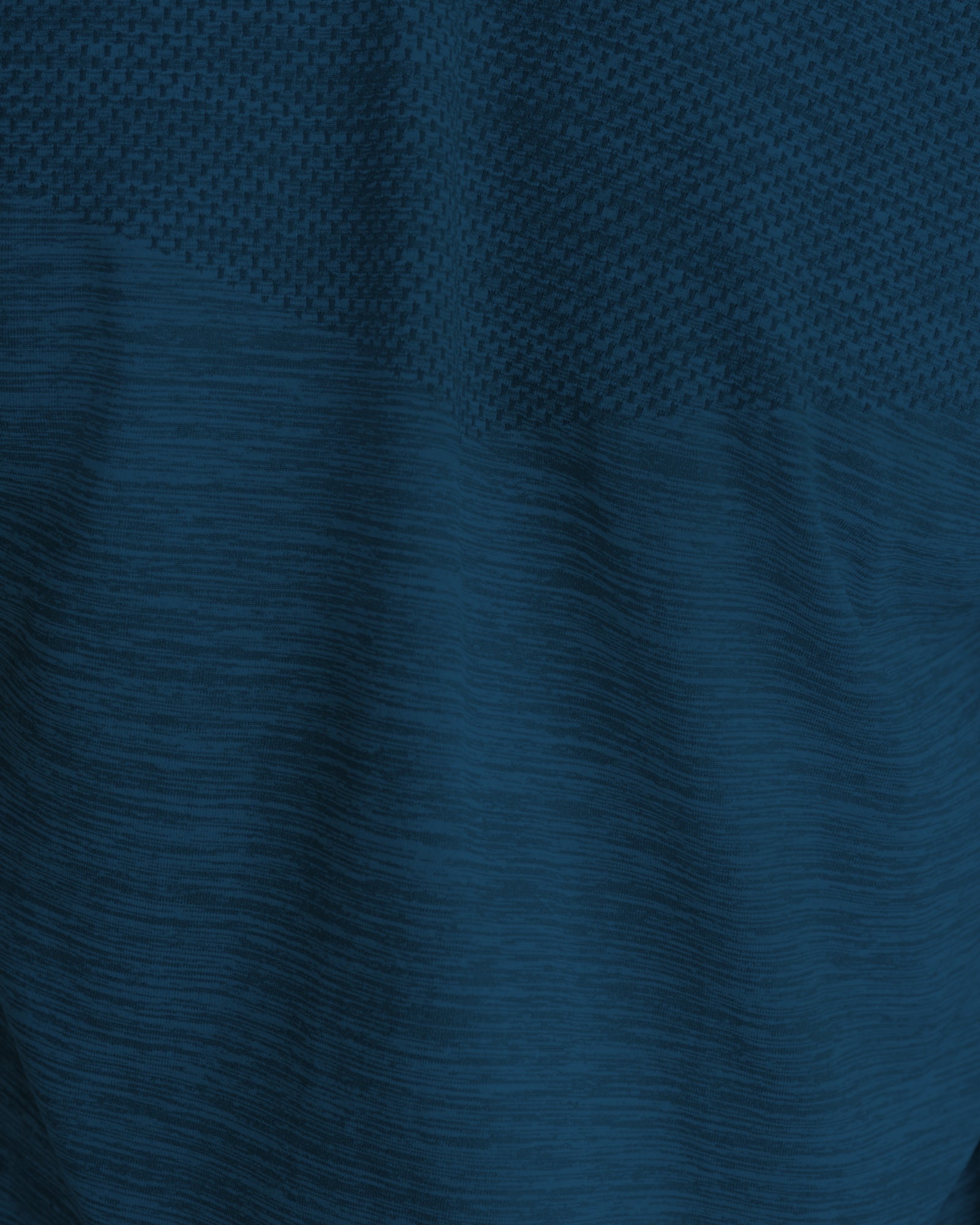 Close-up of the Seamless Tee in Midnight Navy showing textured fabric detail with waffle-knit upper panel.
