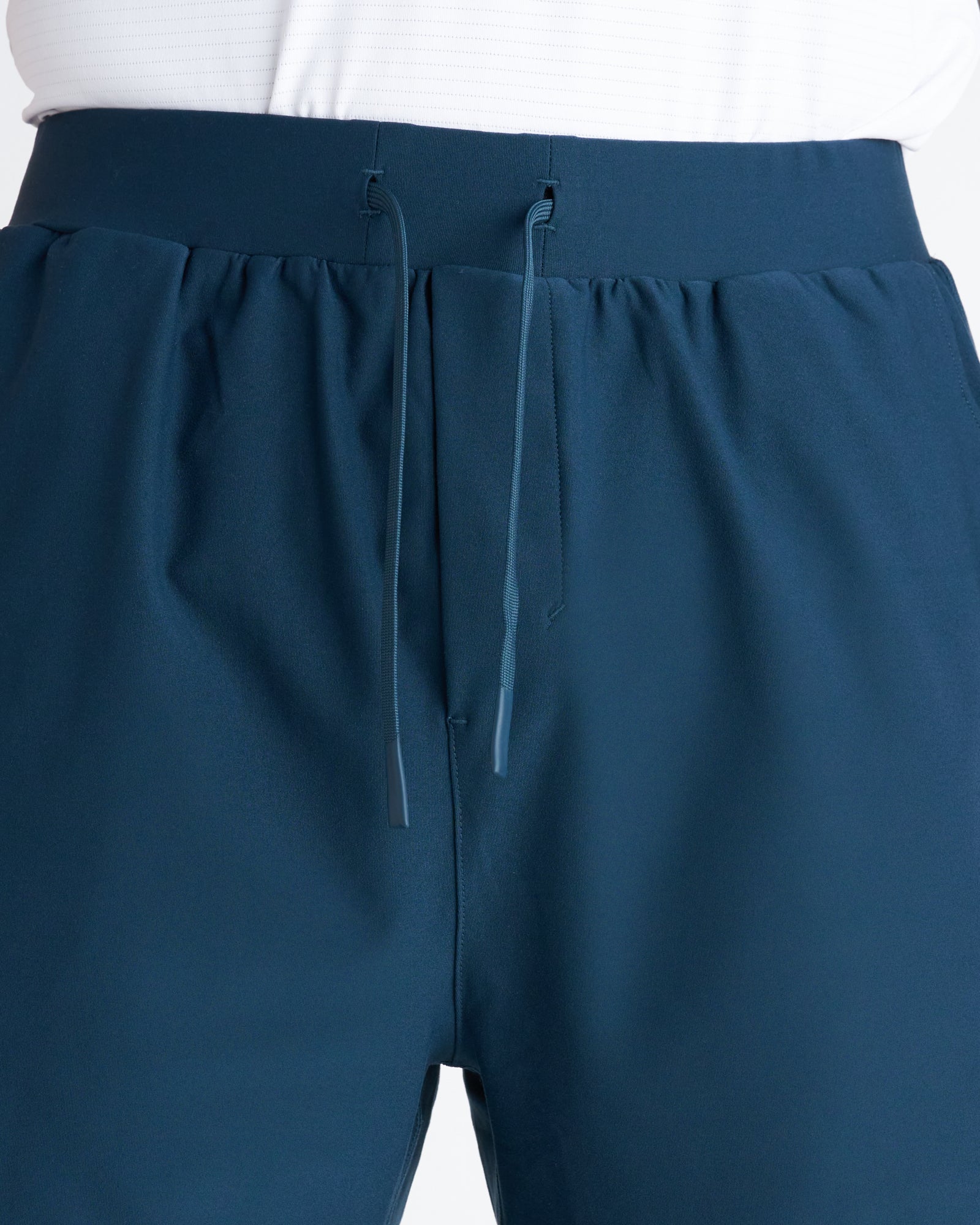 Close-up of Haven Performance Short in Midnight Navy showing elastic waistband, tonal drawstring, and side pocket details.