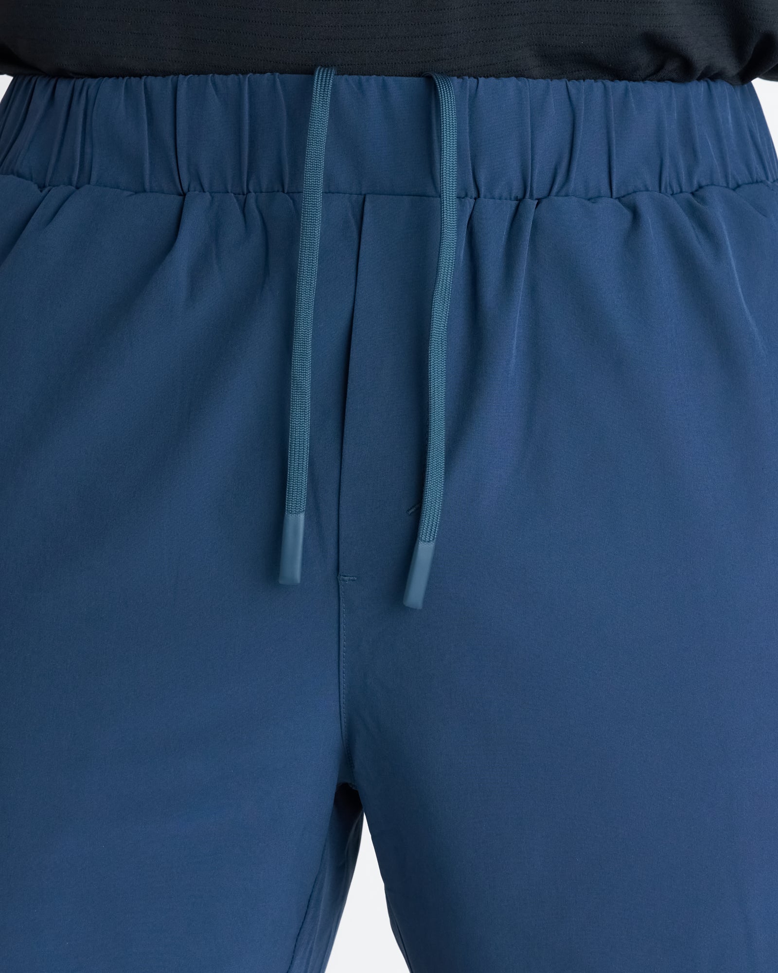 Close-up of Pulse Tech Linerless Short in Midnight Navy showing elastic waistband and tonal drawstring detail.
