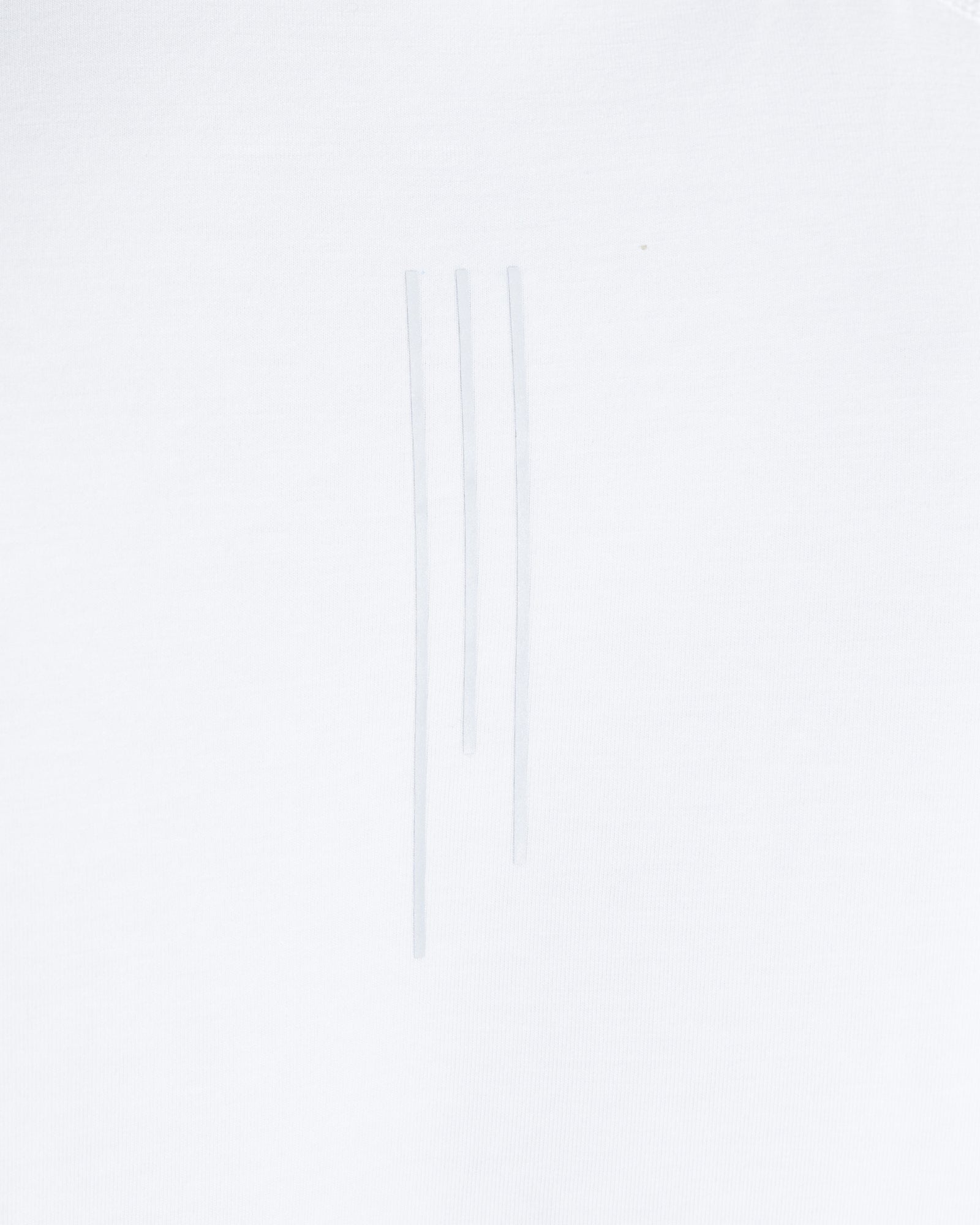 Close-up detail of three white drawcord strings on the Core Raglan Cutoff white tank top.